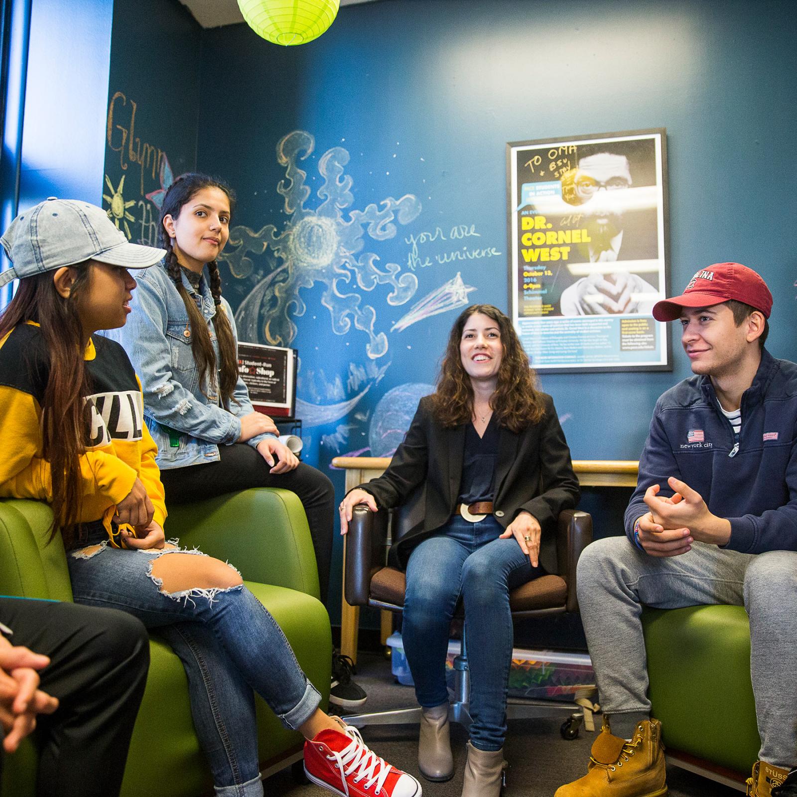 Pace students sitting on couches laughing and talking.