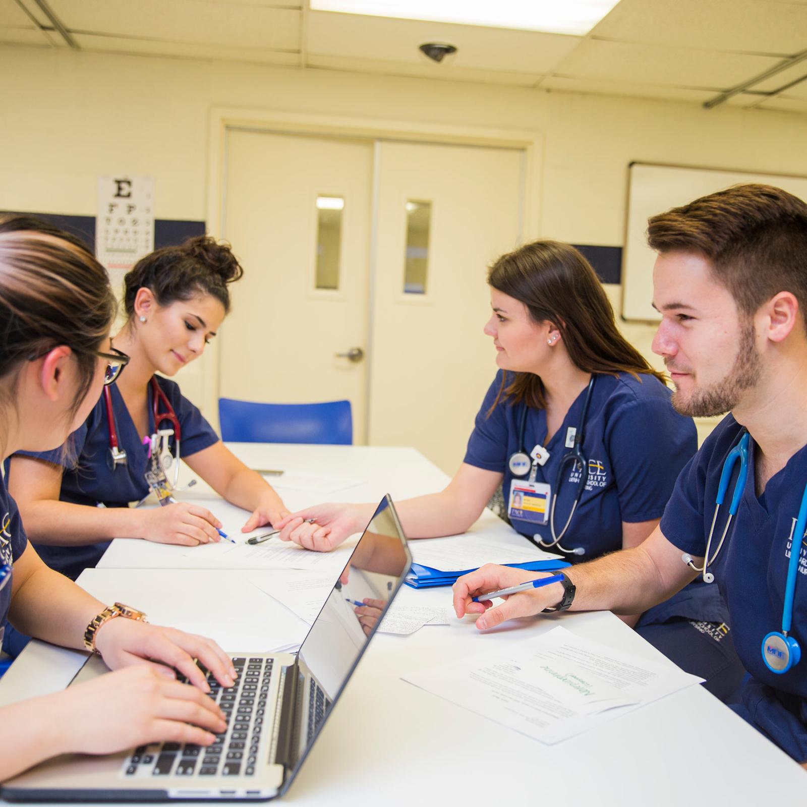 CHP students sitting at a desk studying.