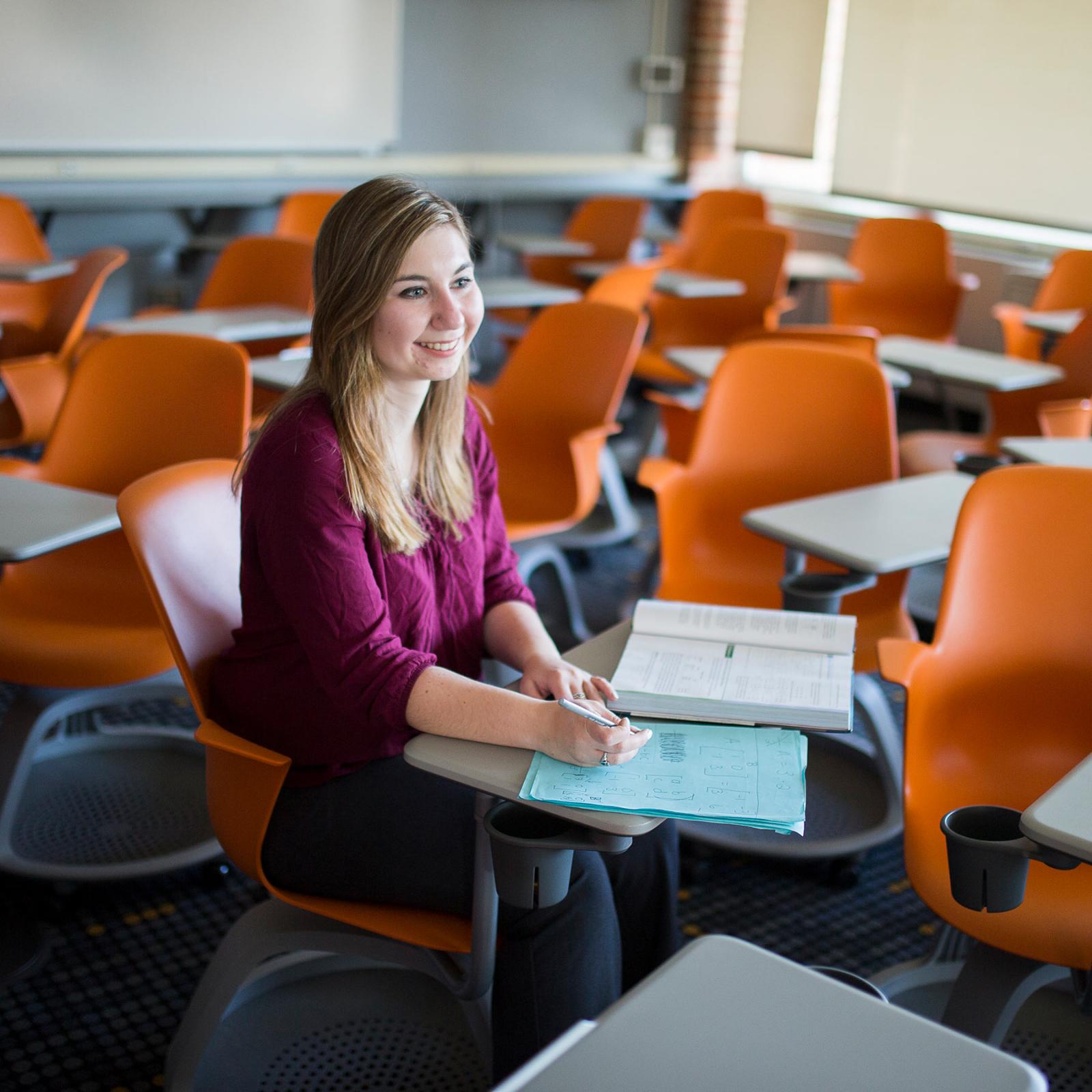 School of Education student sitting in a classroom studying.