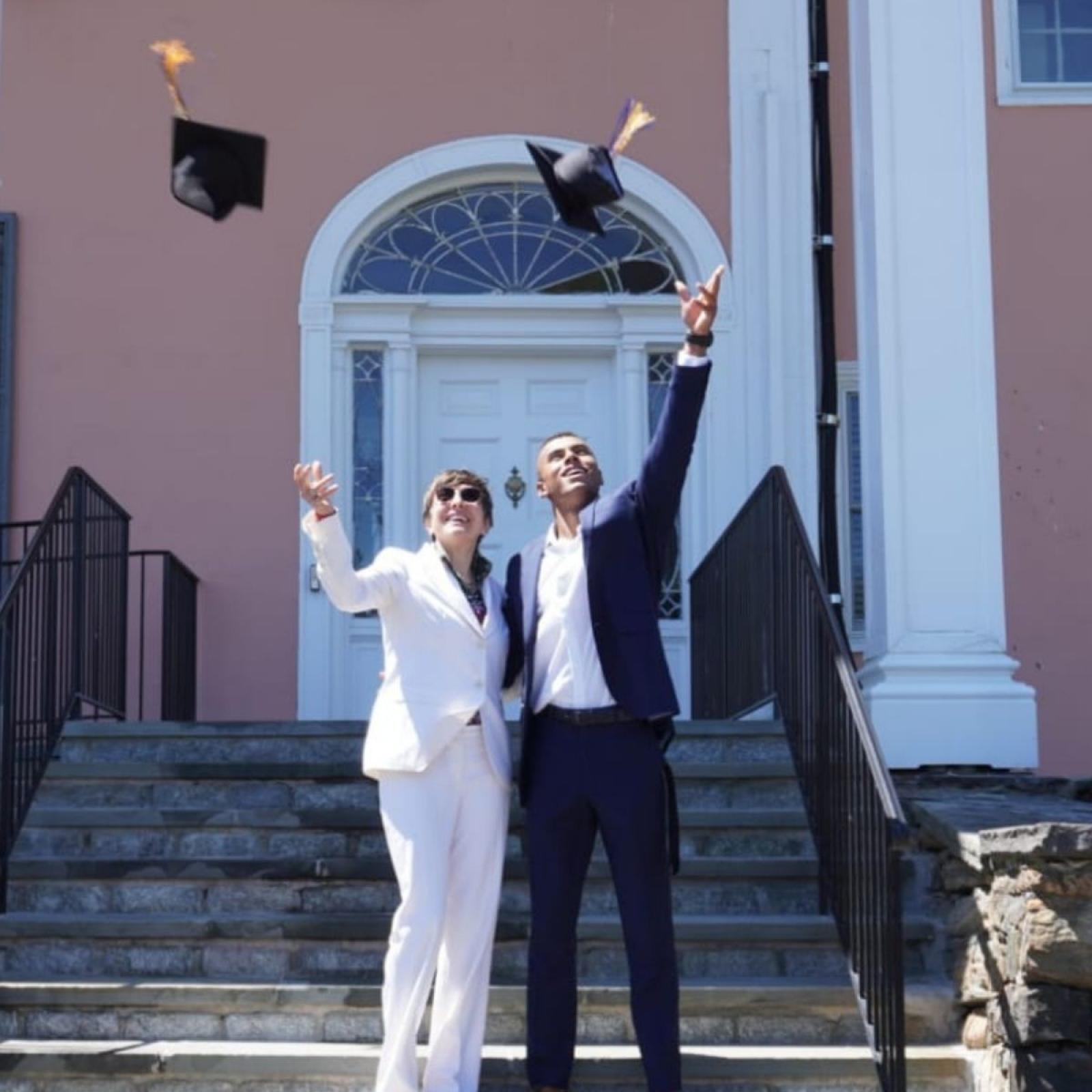 Graduates throwing caps in air
