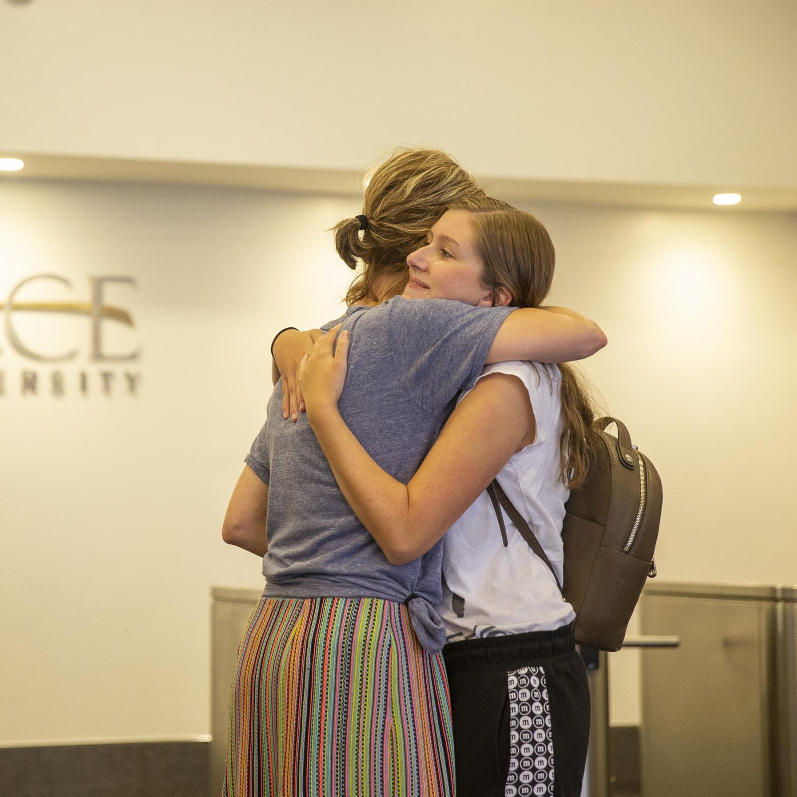 a mother and daughter hugging