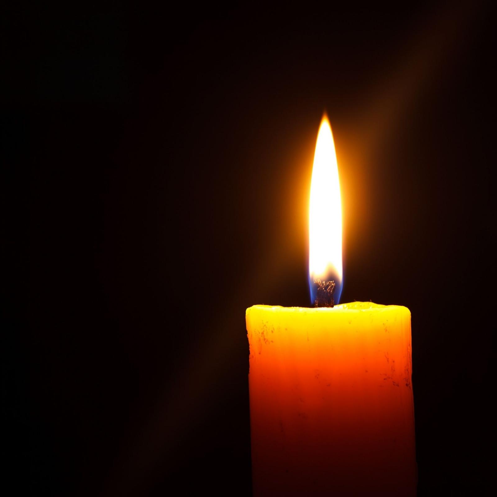 burning candle in a dark room