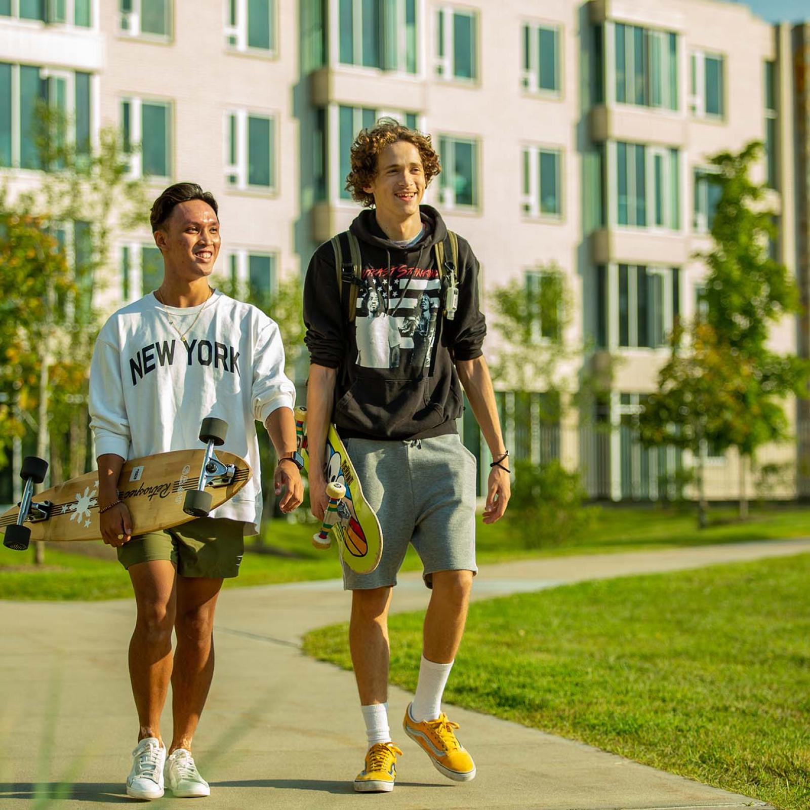students with skateboards walking on Westchester Campus