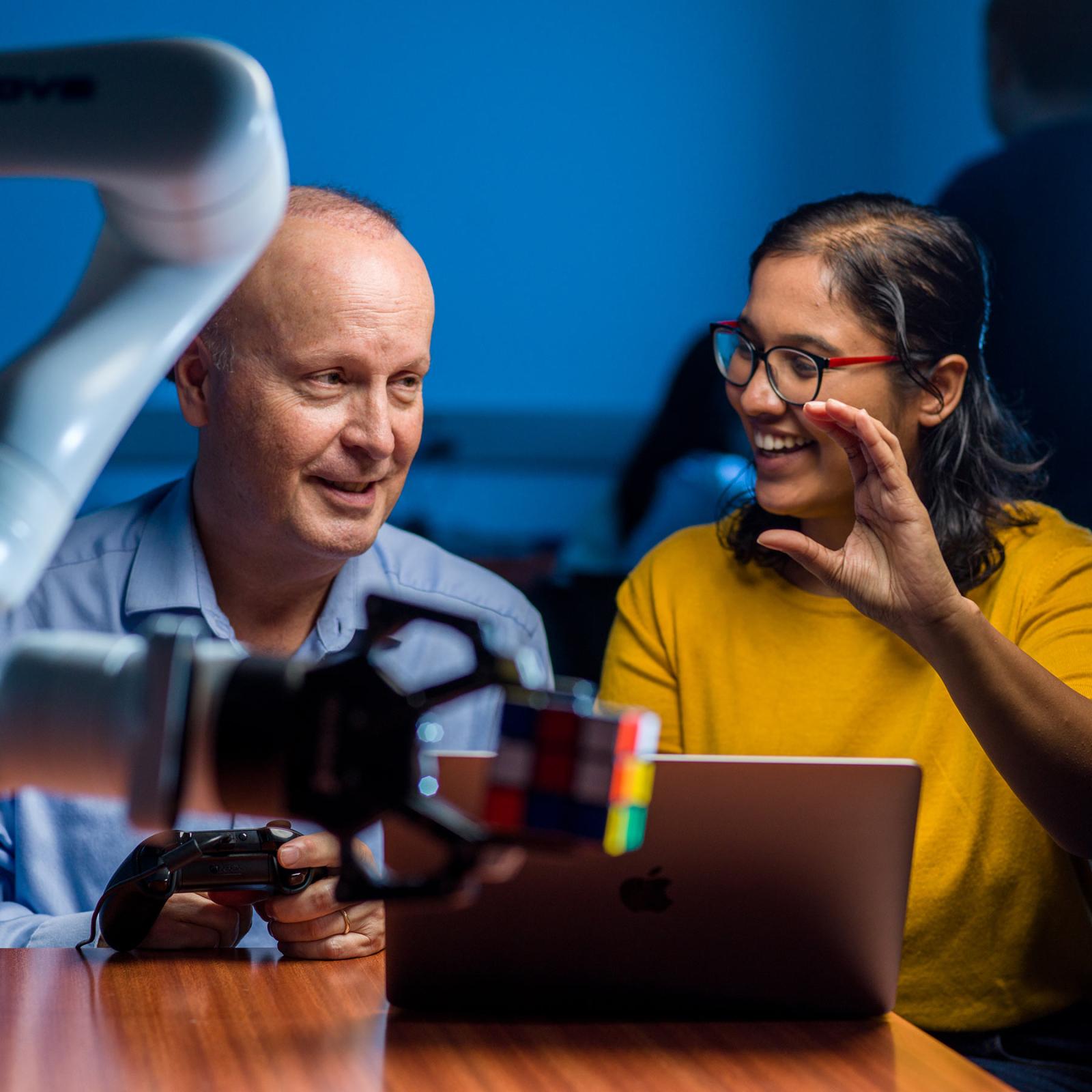 Seidenberg student working with a faculty member in the Robotics Lab.