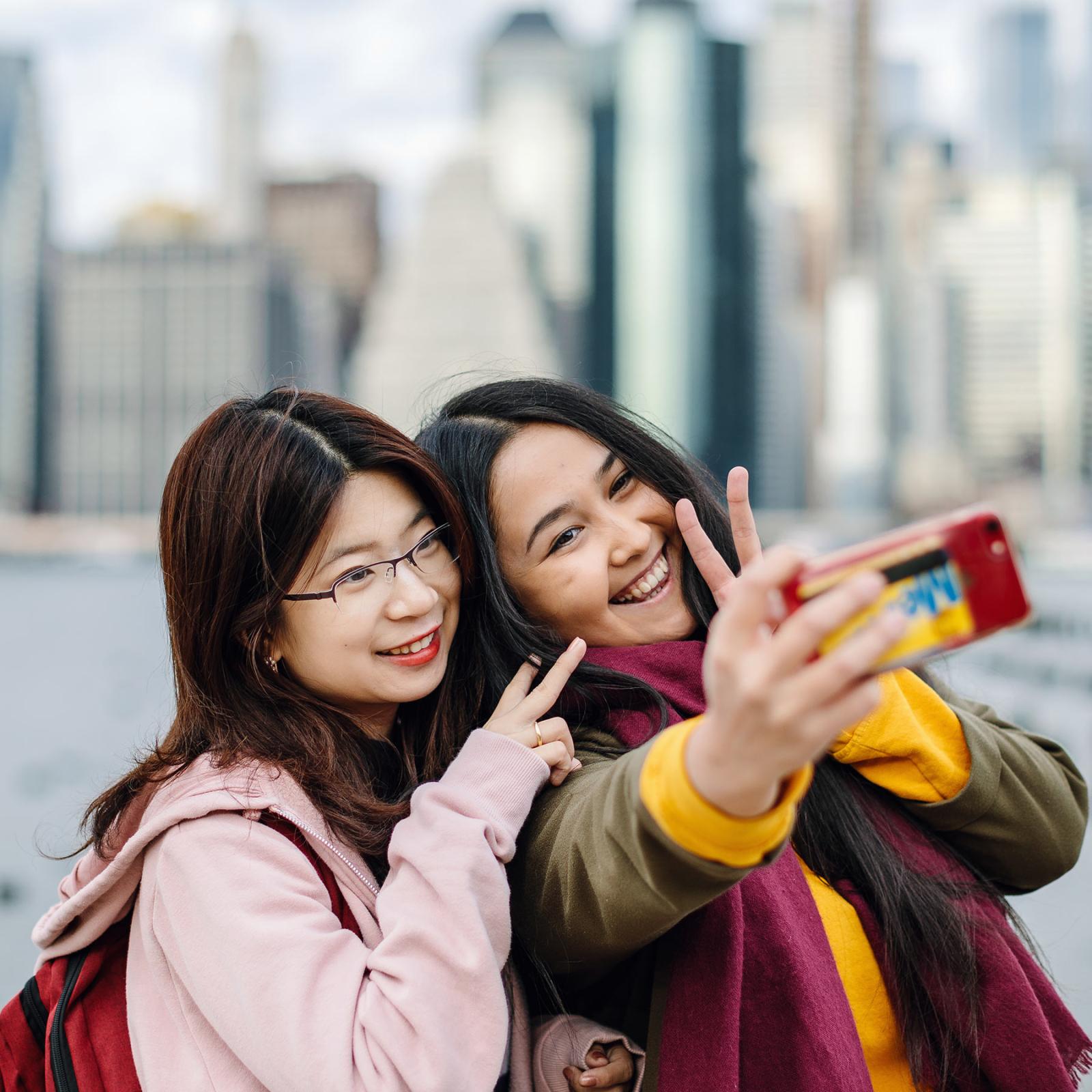 Two female pace students taking a selfy on the Brooklyn Bridge