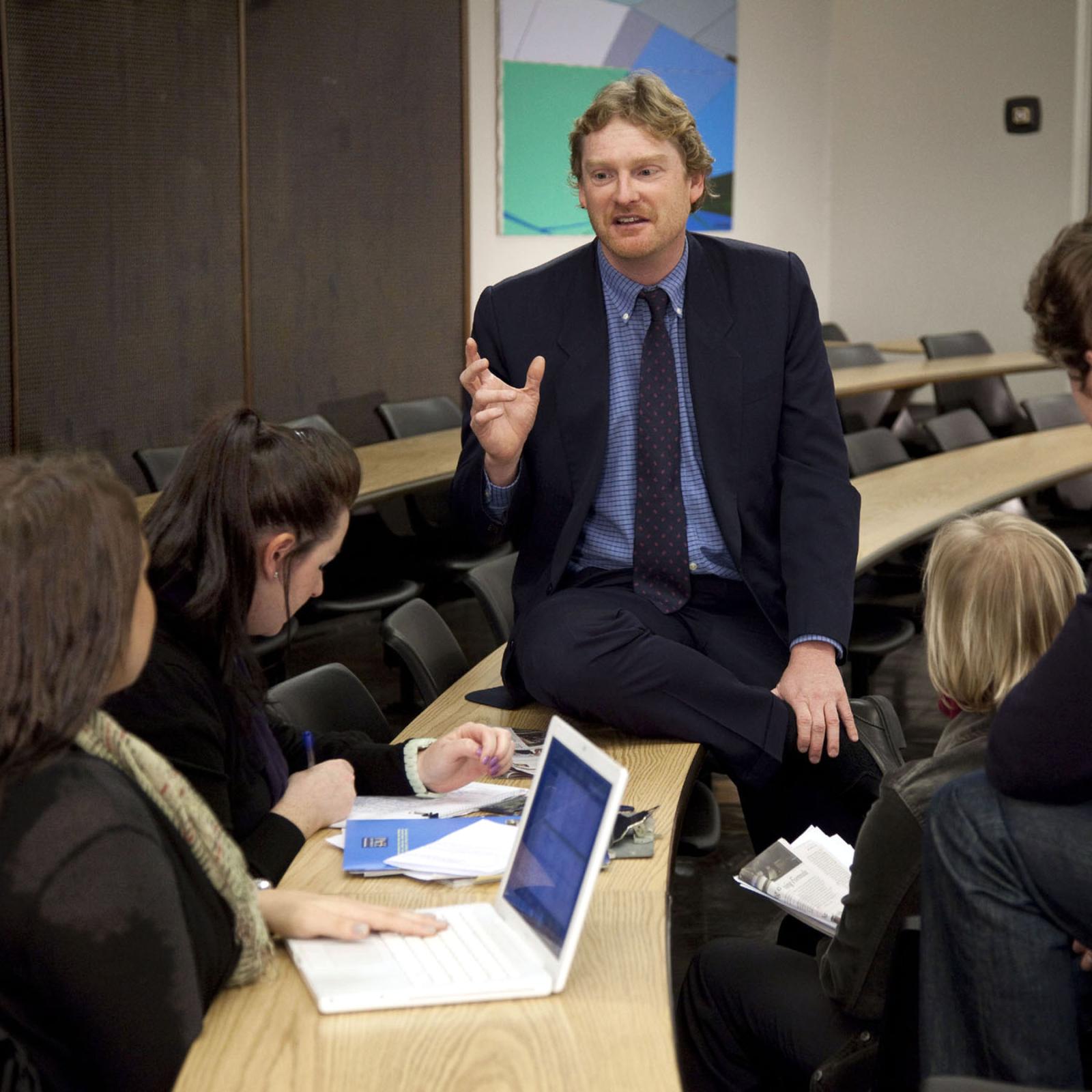 finance professor Matthew Morey teaching students in a classroom at One Pace Plaza