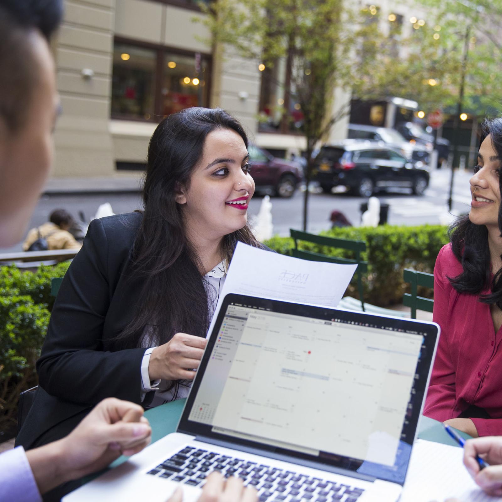 Lubin graduate students sitting at an outdoor plaza in Lower Manhattan near the New York City Campus