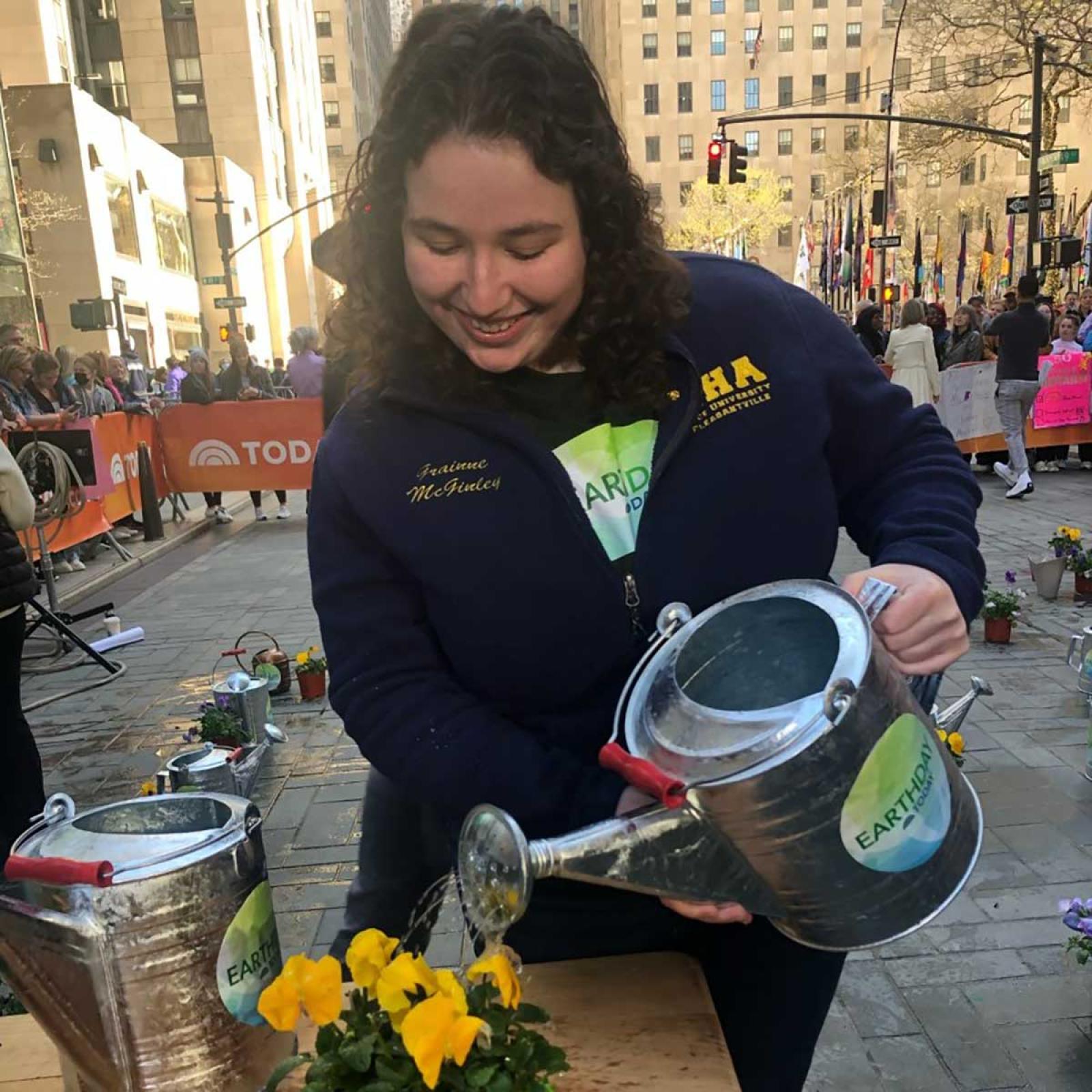 Pace student Grainne McGinley watering a plant at the Today Show
