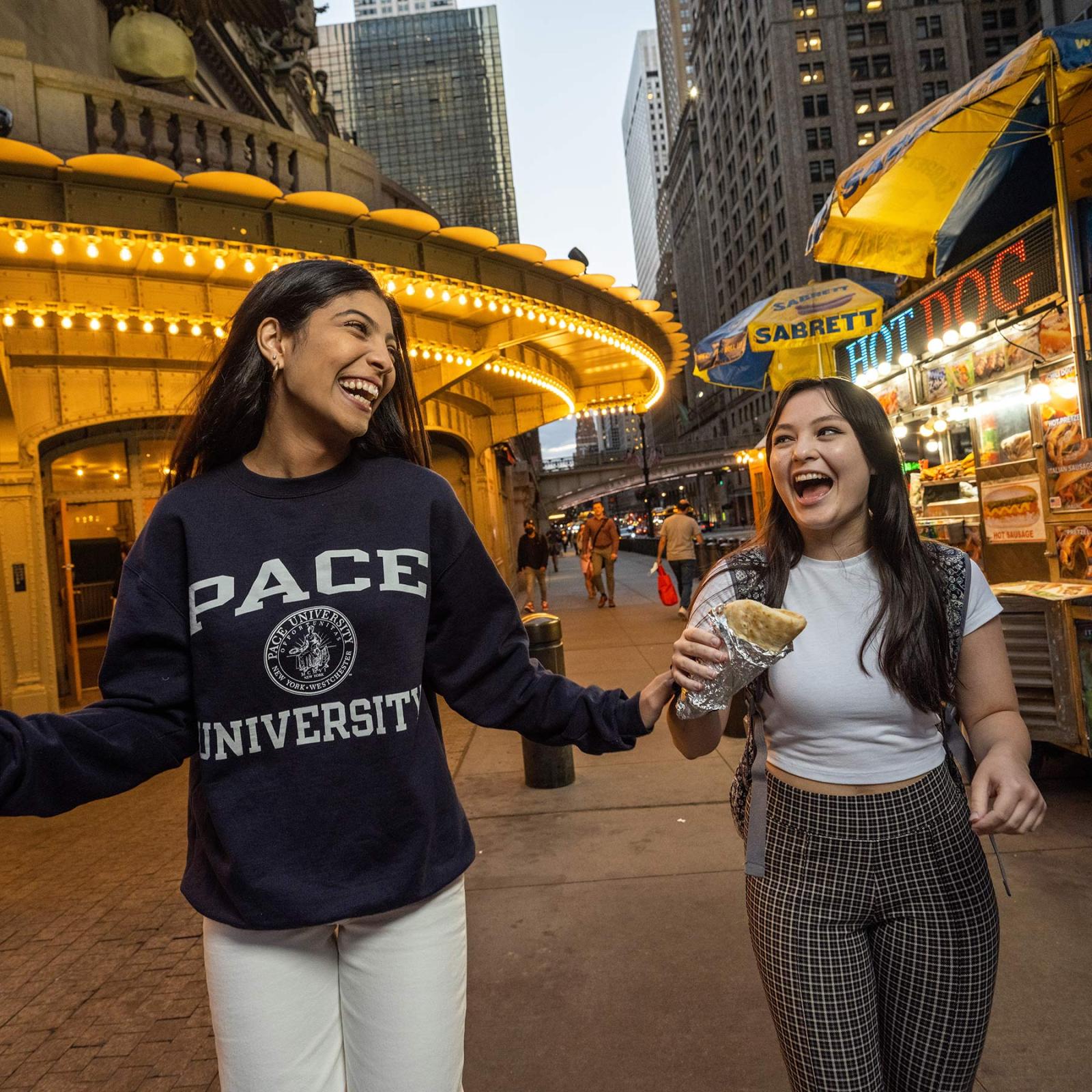 Two students laughing in the street of New York city