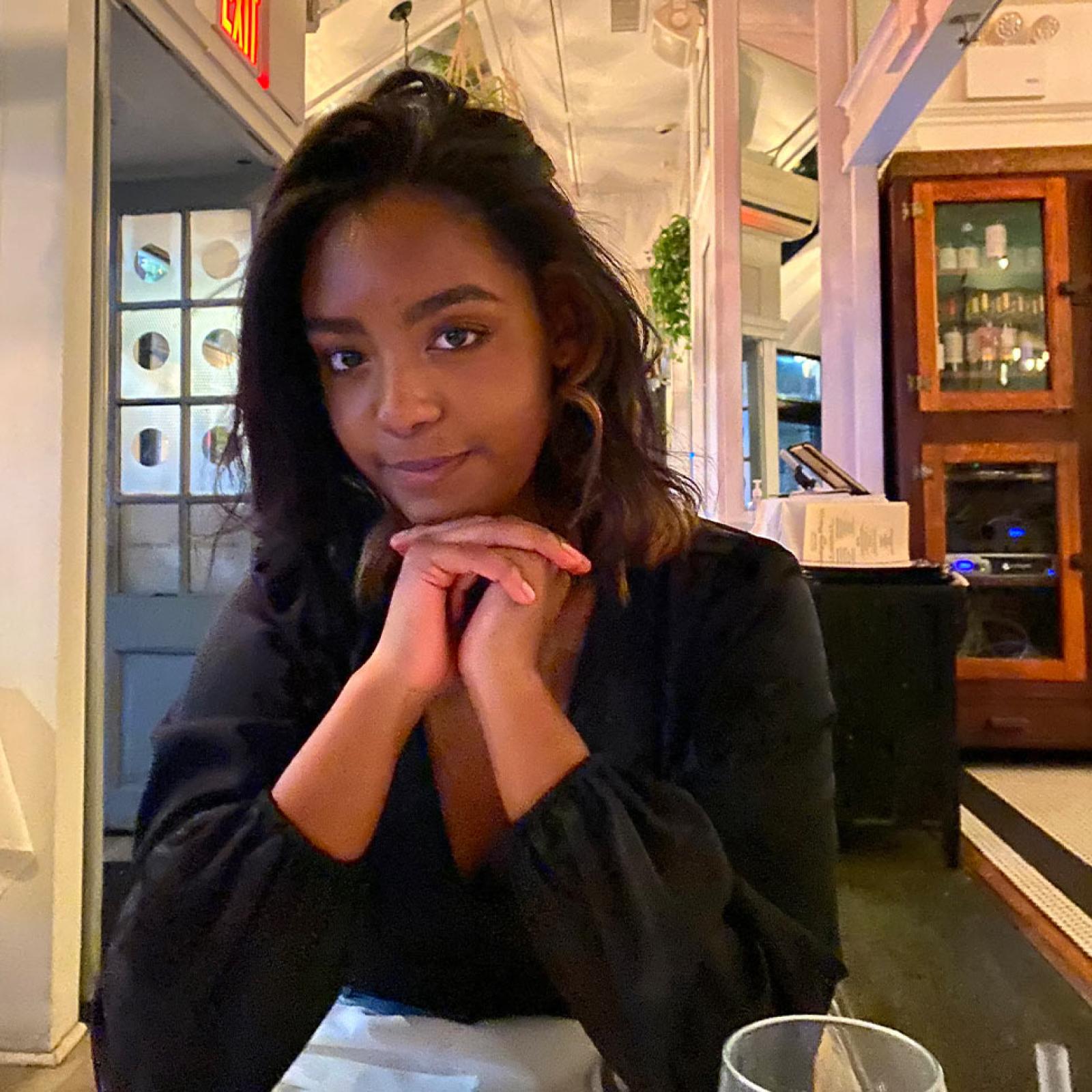 young woman resting chin on hands