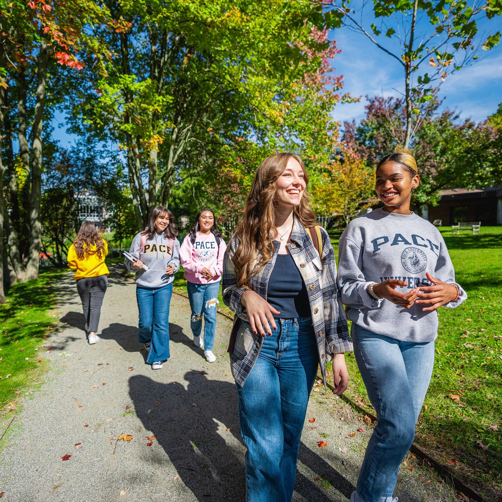 Two pairs of Pace students walking outside on Pleasantville Campus