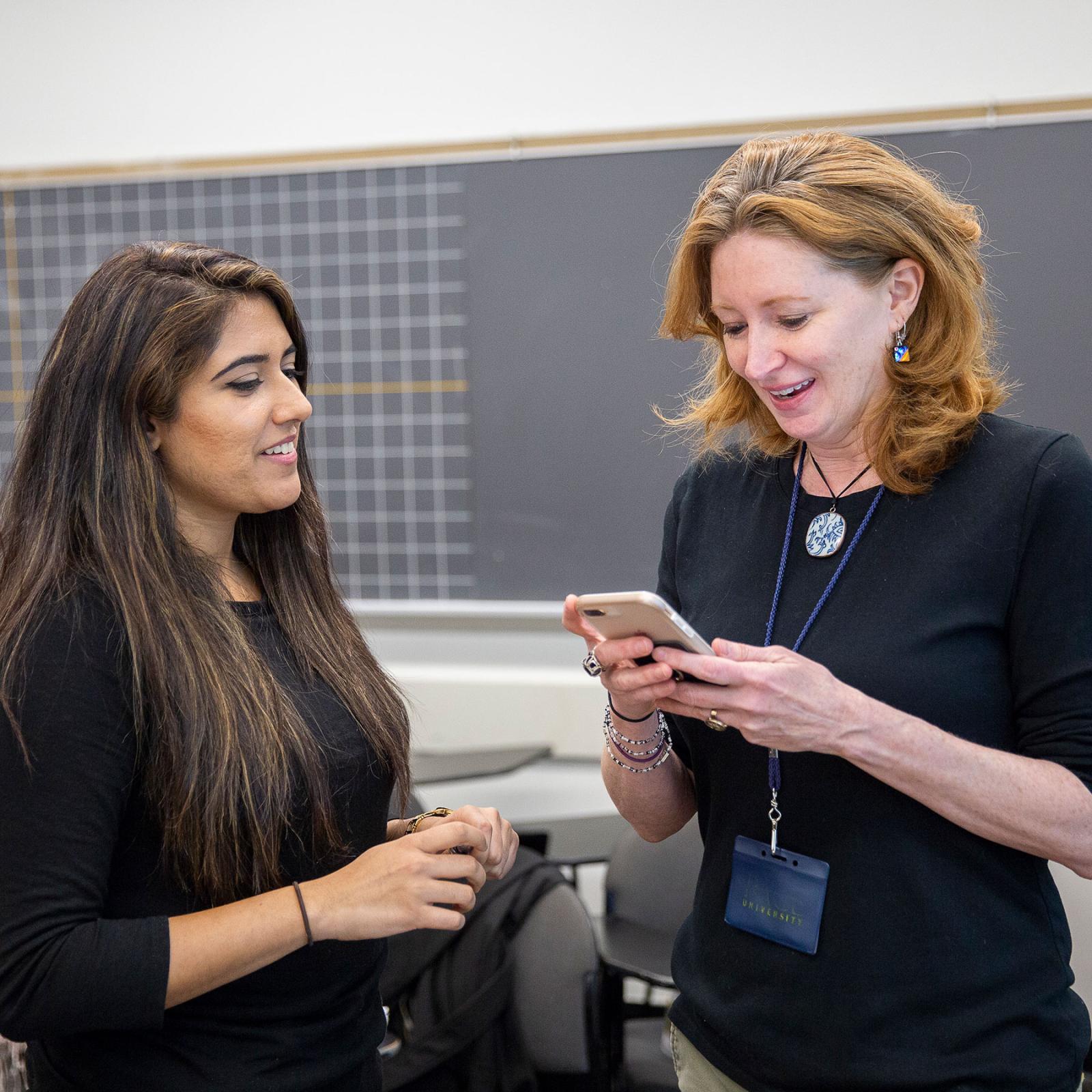 two women using an iphone