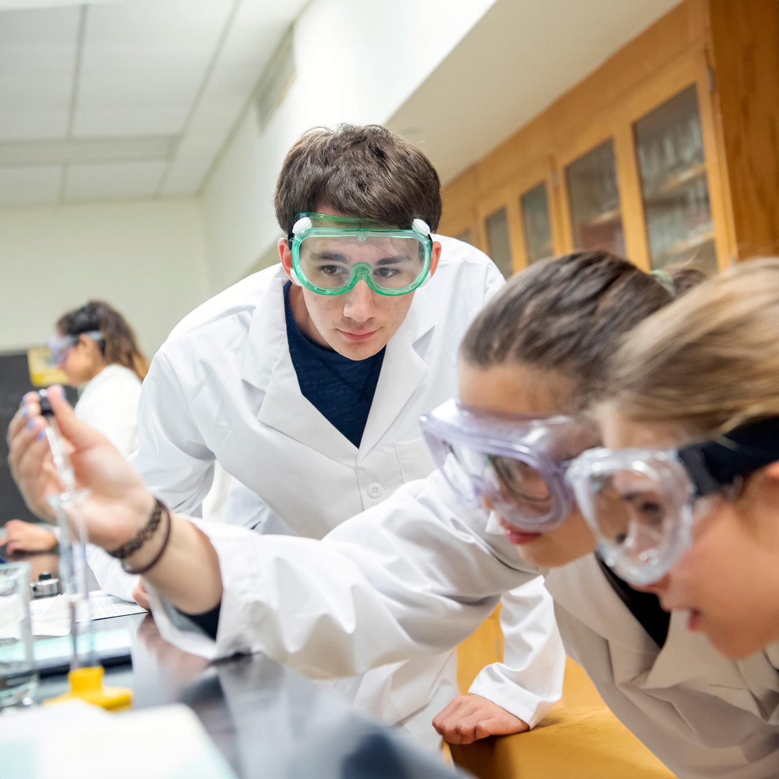 Pace University's Pleasantville Chemistry lab students working with beaker and solution