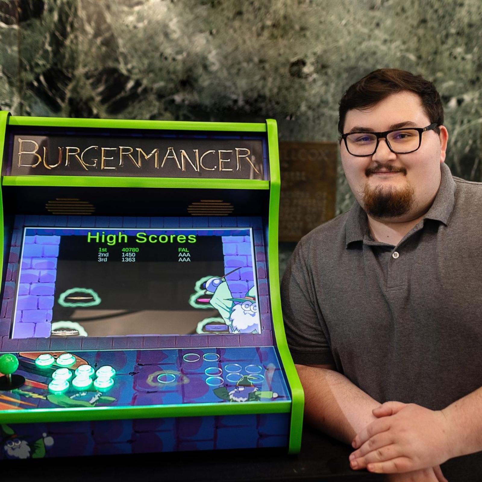 Pace University Seidenberg student, Michael Falco with his arcade video game, Burgermancer