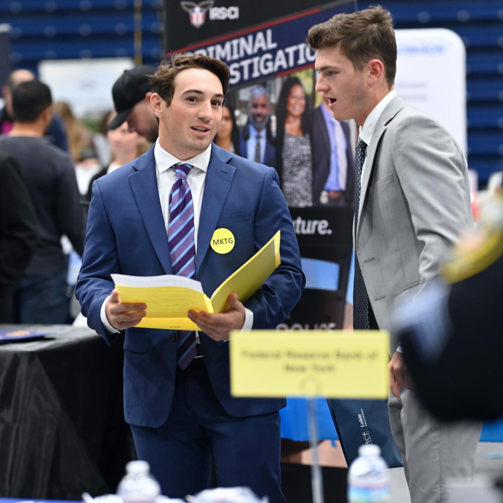 two pace students at an internship fair on campus