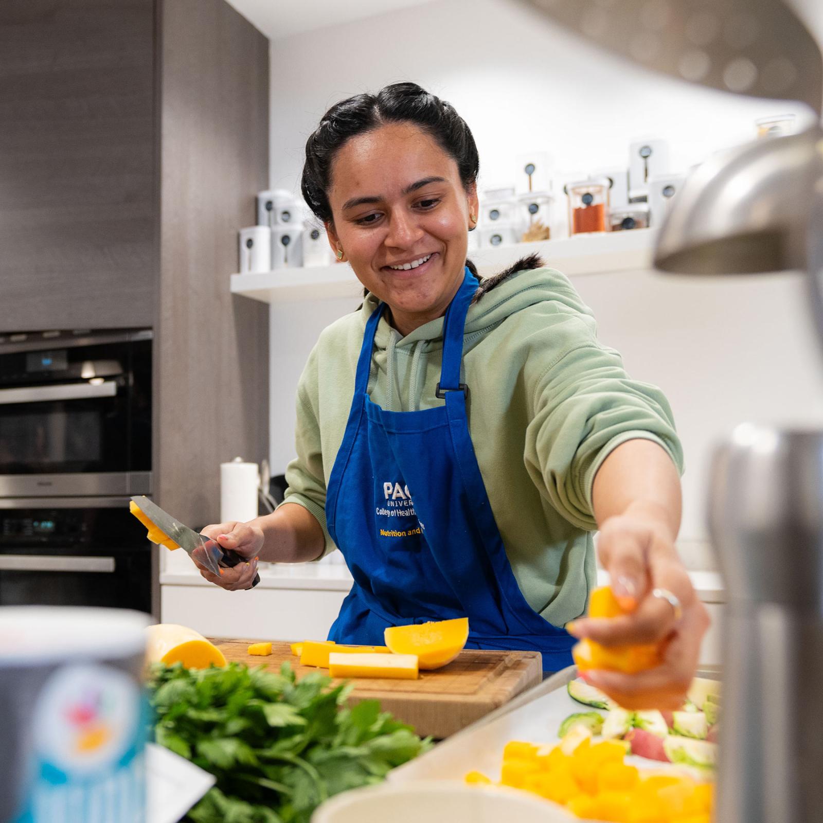 Student from the Pace University College of Health Professions, cooking in the Teaching Kitchen