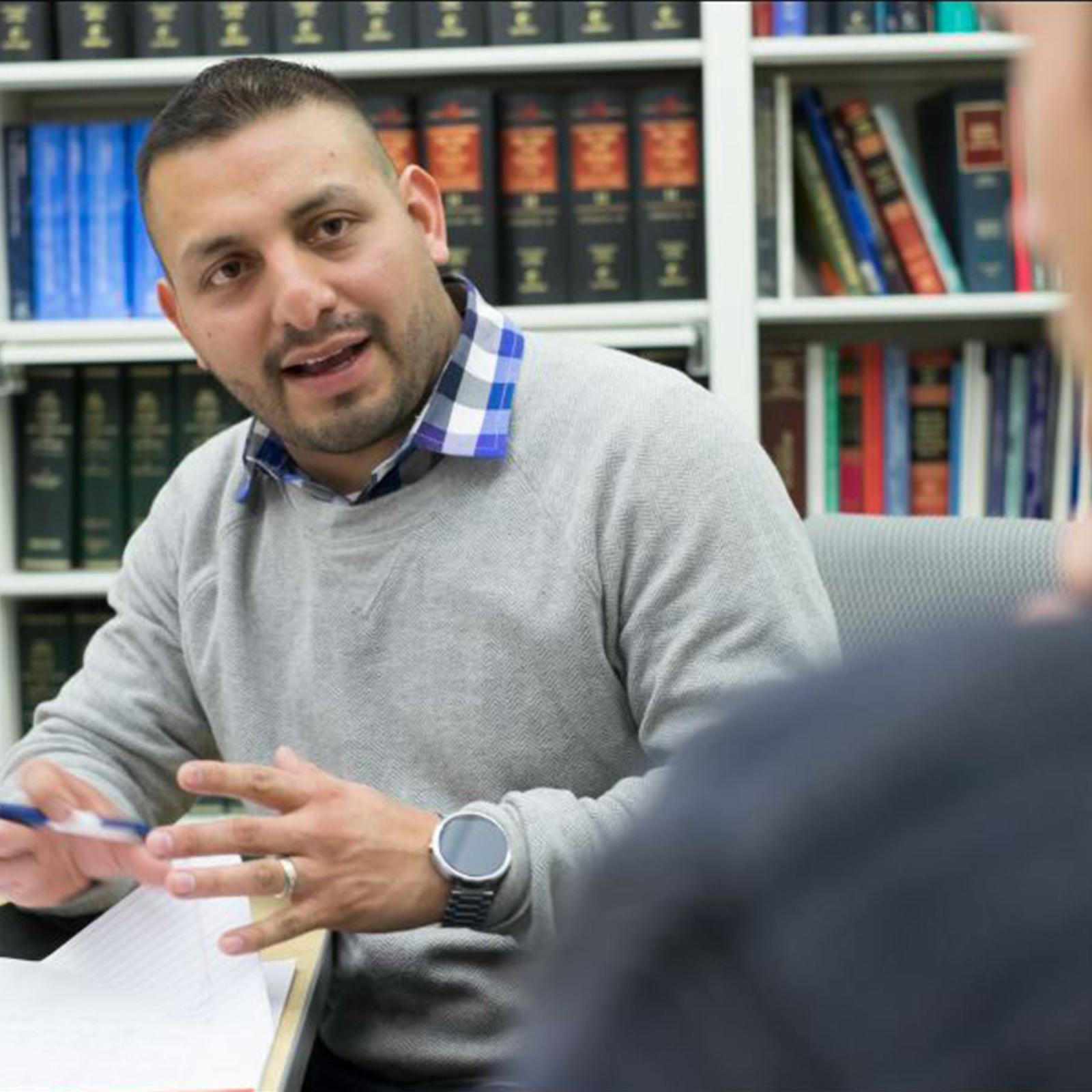 Elisabeth Haub School of Law professor talking to a student in the Haub Law Library