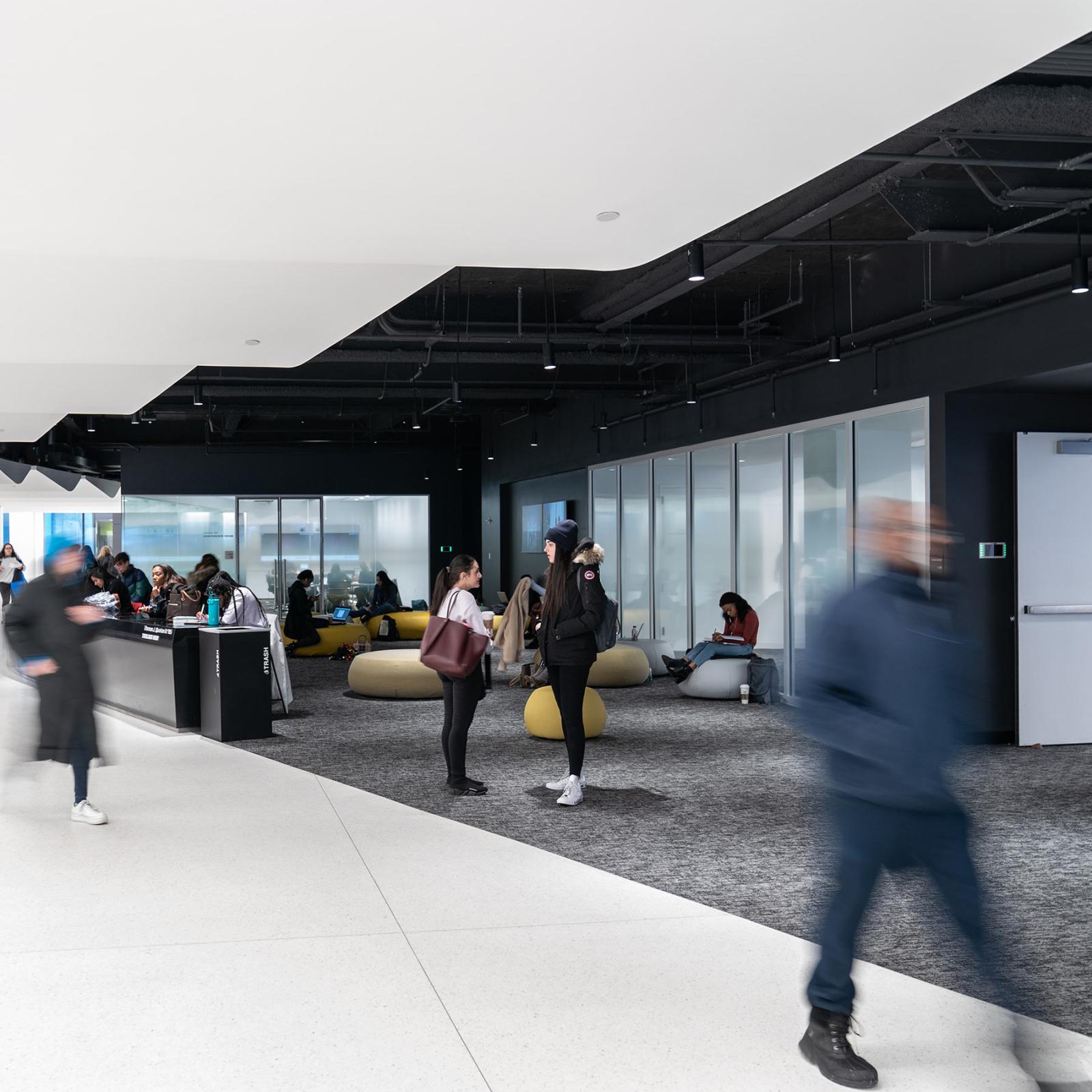 Students walking through the halls of One Pace Plaza on the Pace University NYC campus.