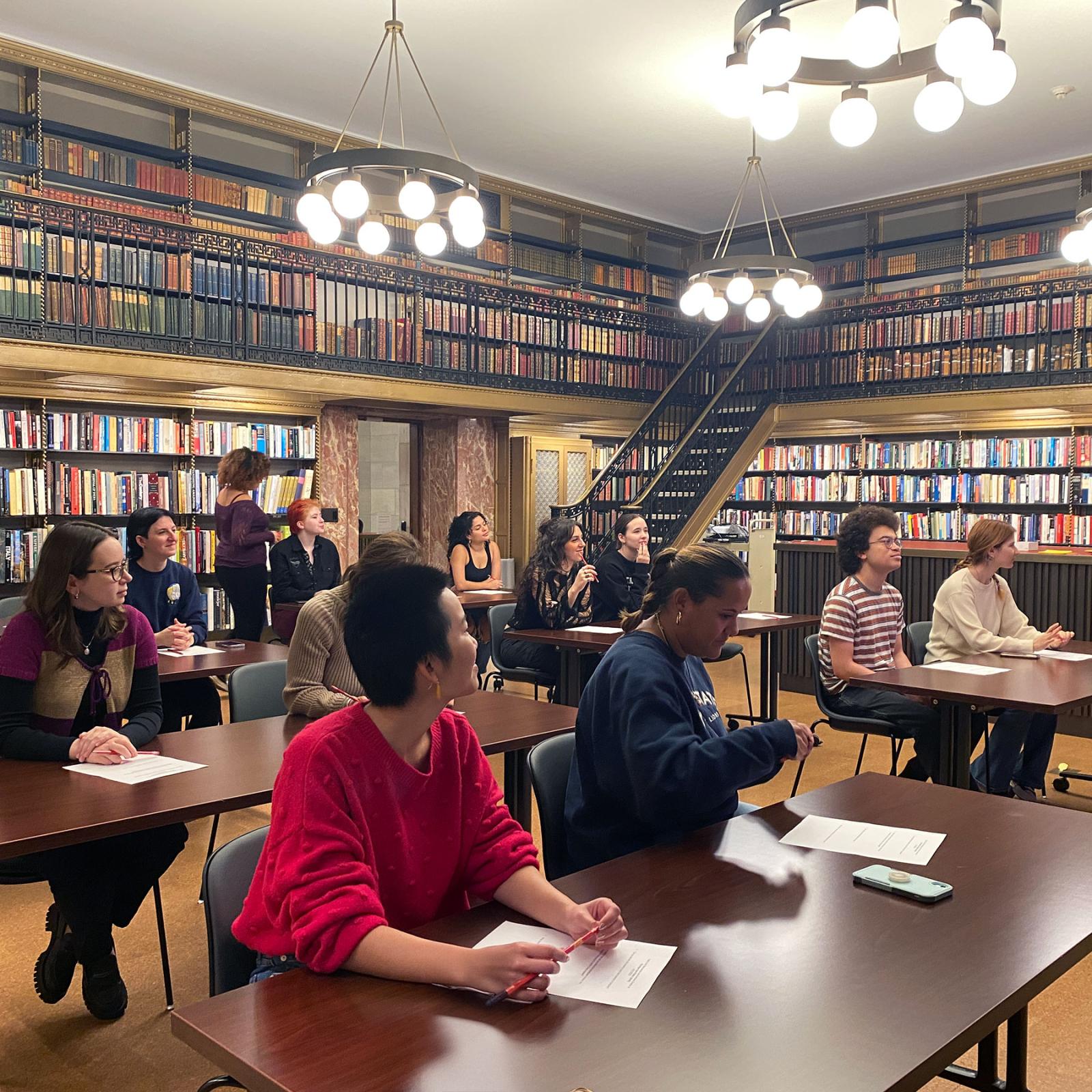 Pace University Women's and Gender Studies students sitting at tables in the New York Public Library