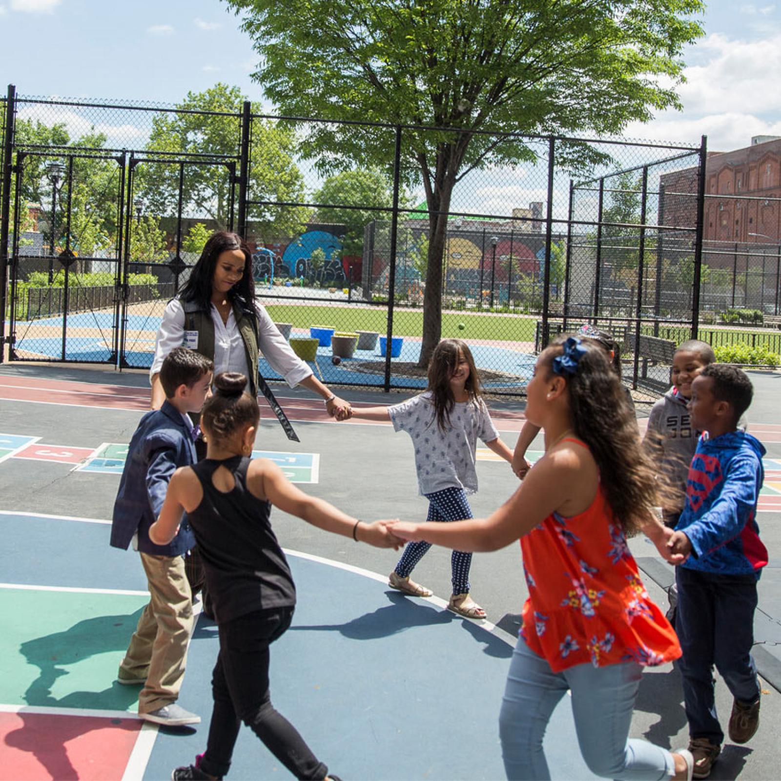 A woman and children on a playground.