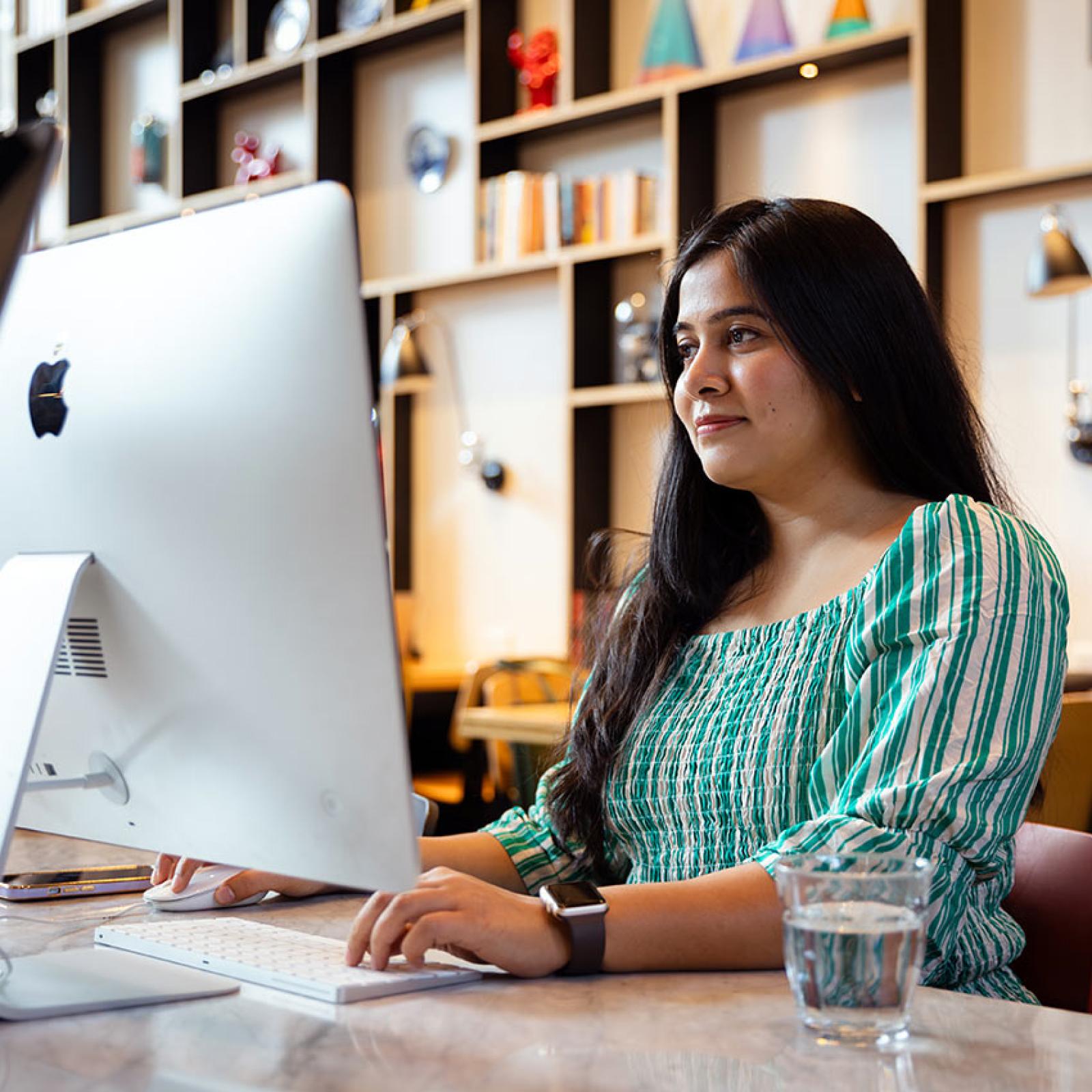 A Pace University student works on a computer screen