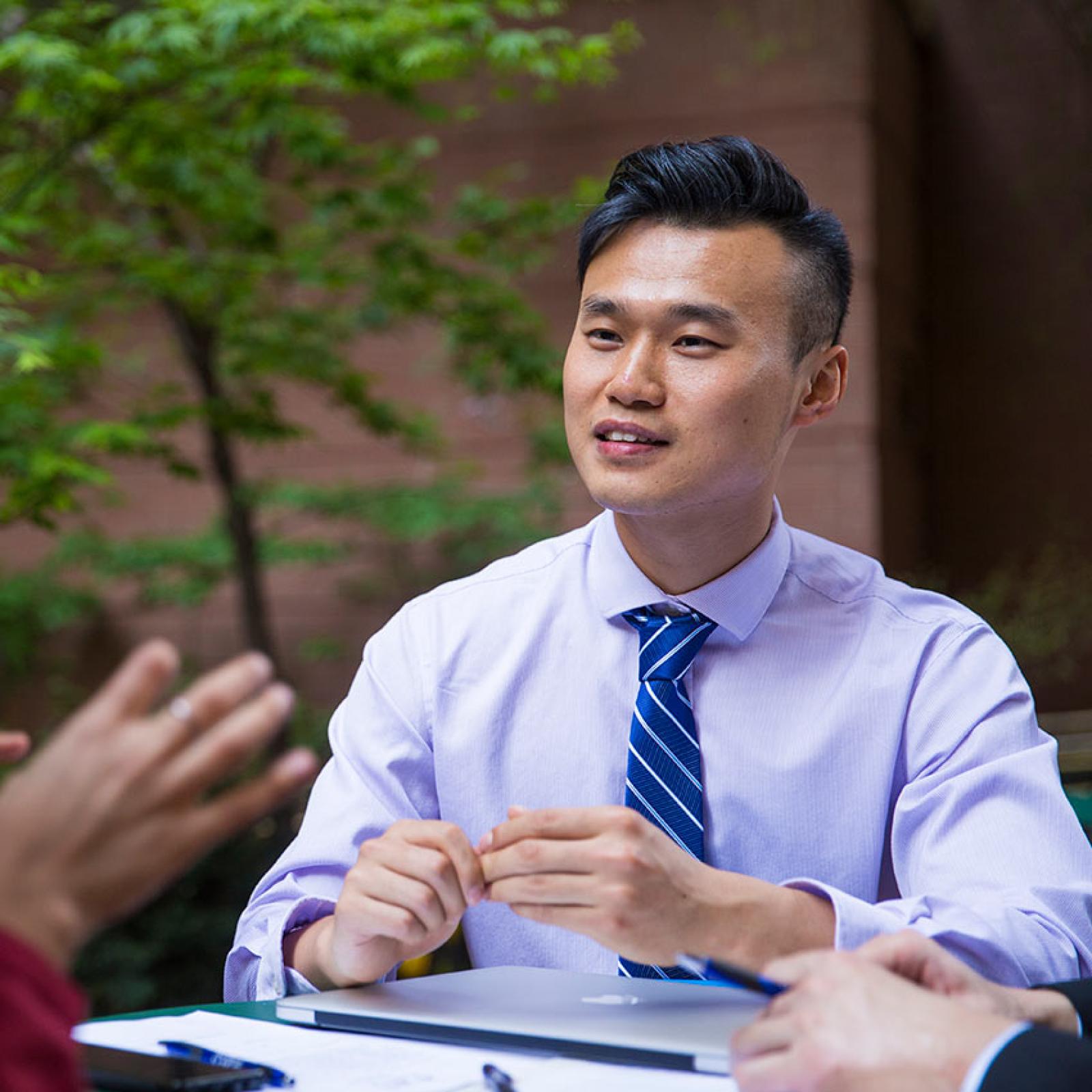 A Pace University student works with others