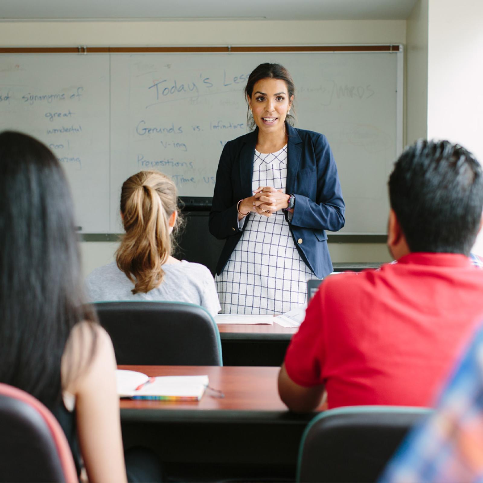 A woman standing in front of a class.