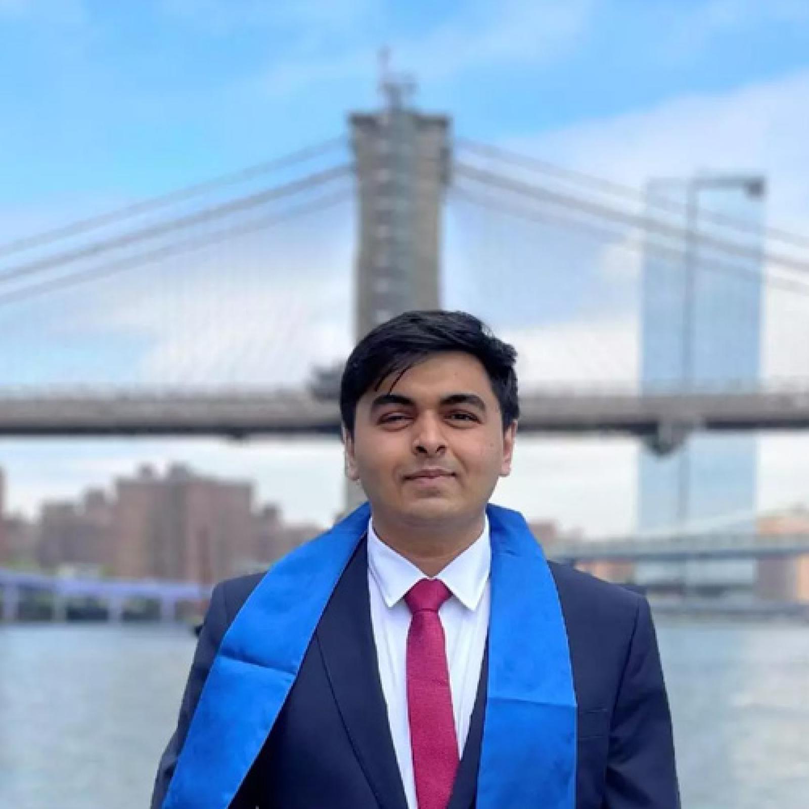 Darshan Vithlani posing in front of the Brooklyn Bridge near Pace University.