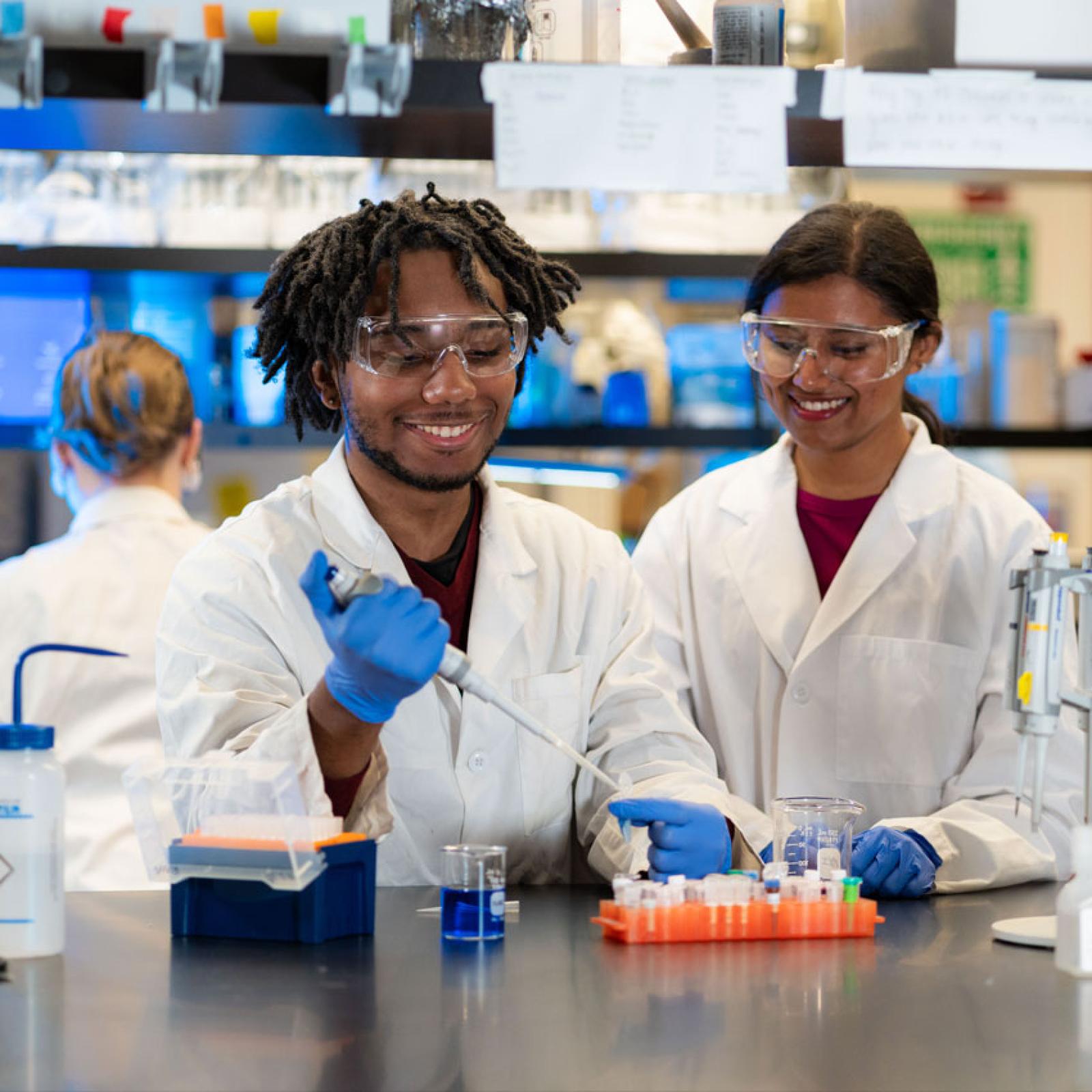 Pace University students in the lab working with droppers.