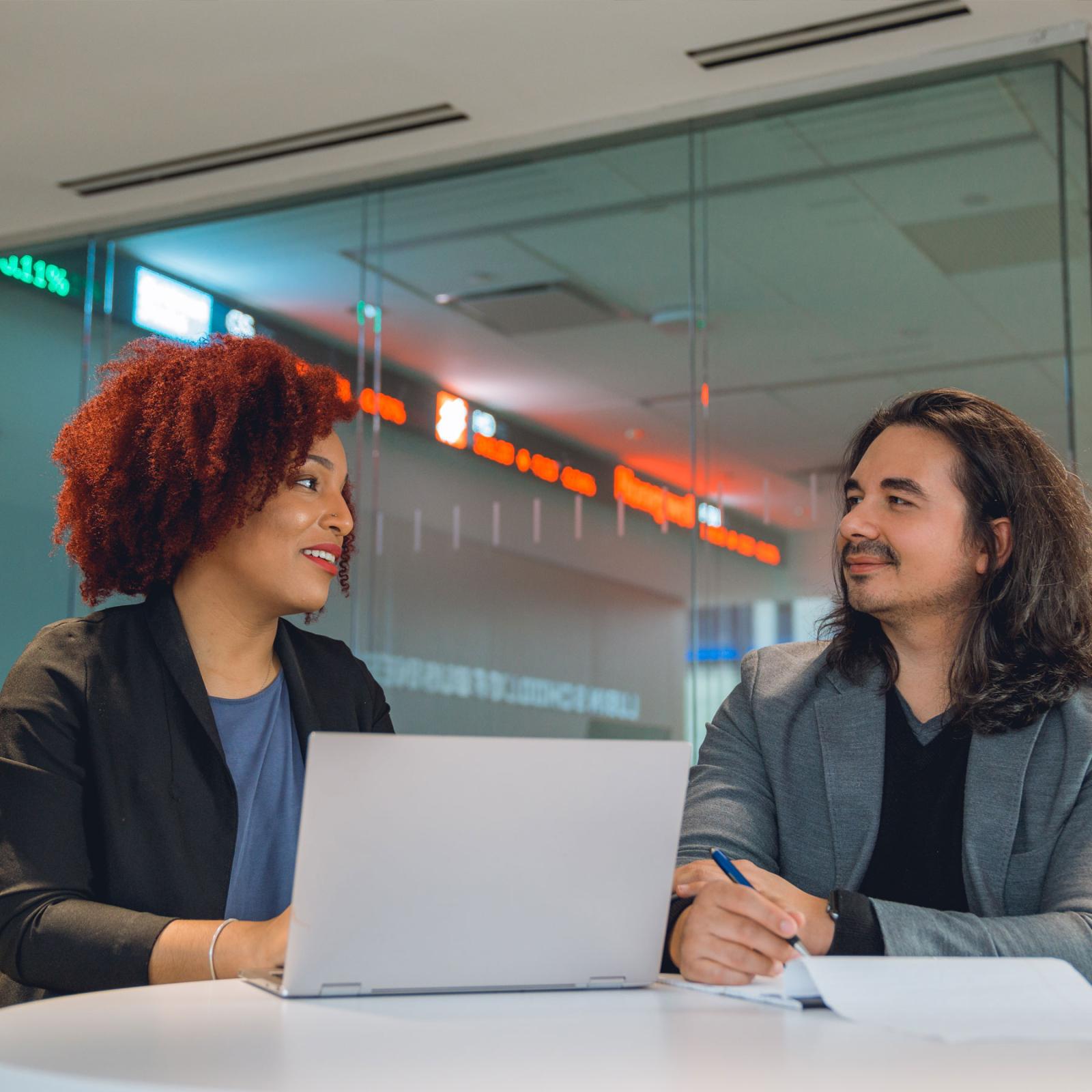 Two people at a table at the Lubin School of Business at Pace University.