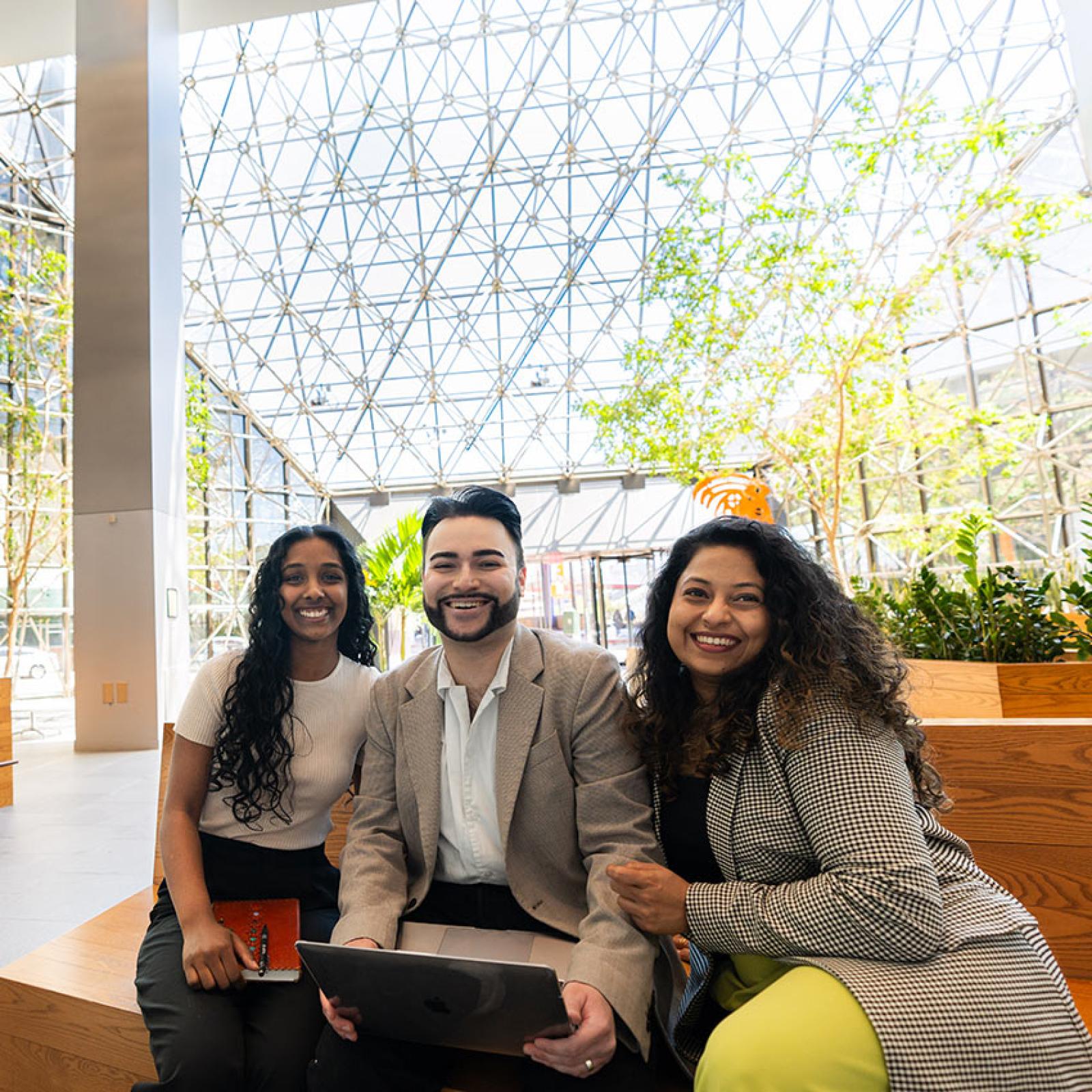 Three Pace students sit on a couch together