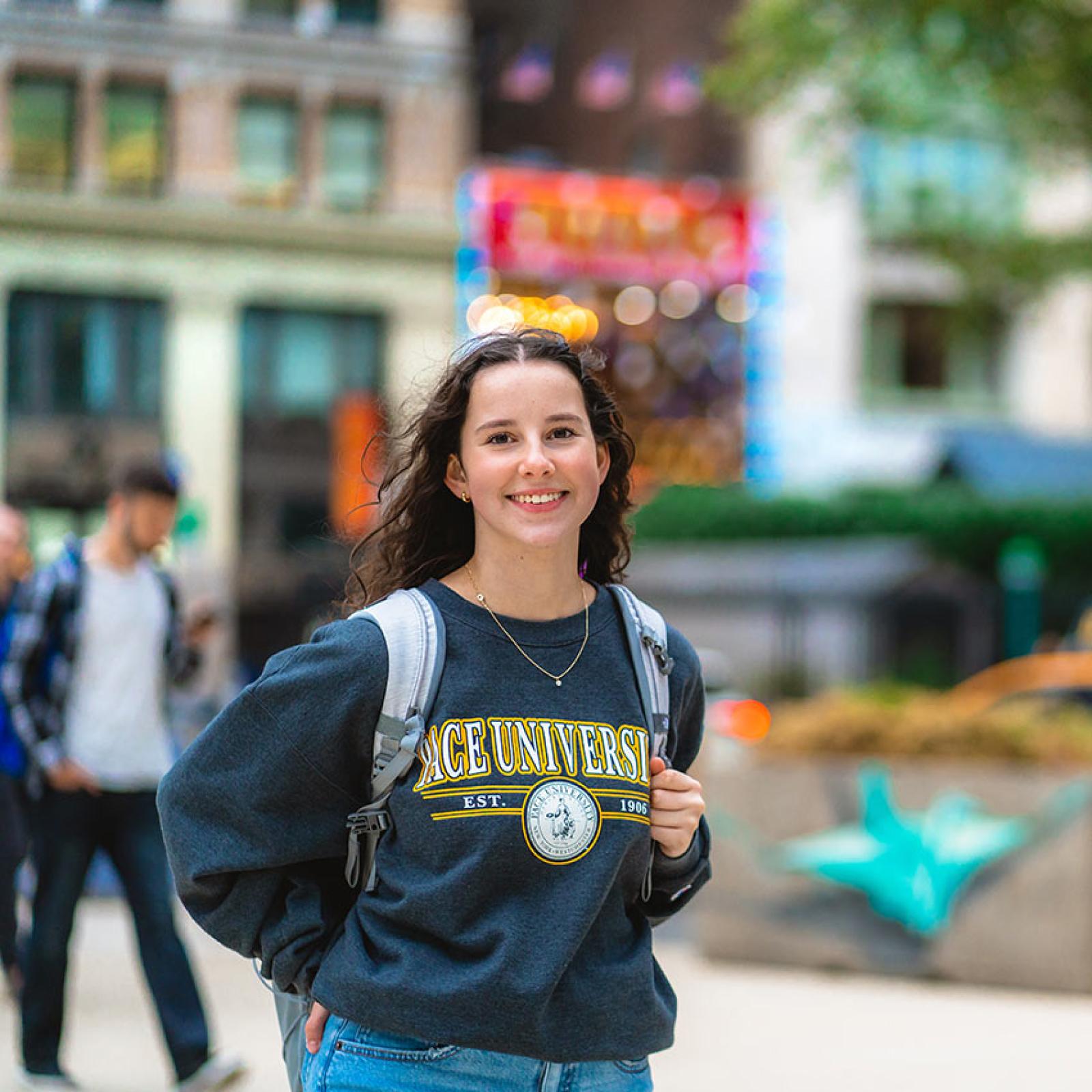 A Pace student stands in downtown NYC