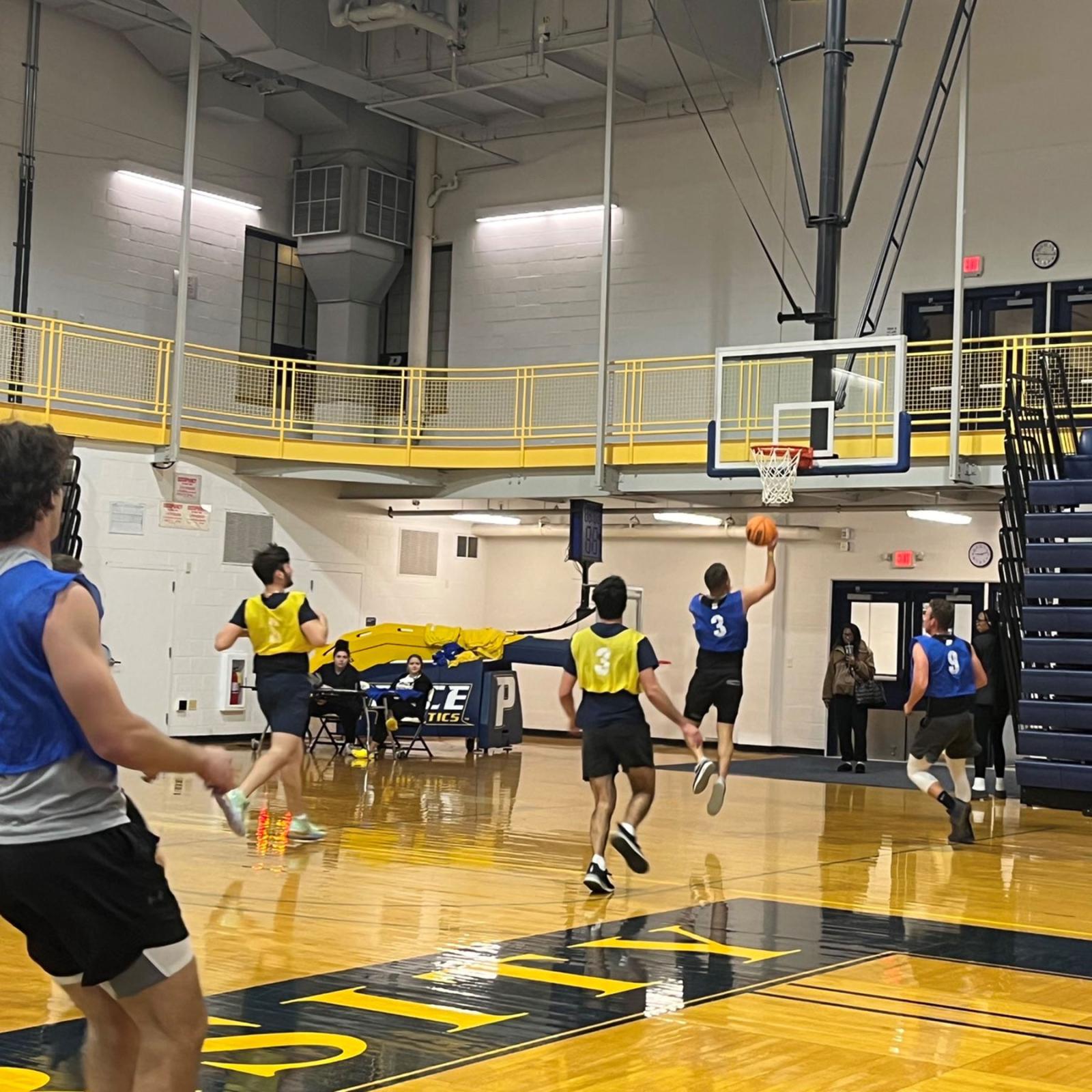 Pace University students playing intramural basketball.