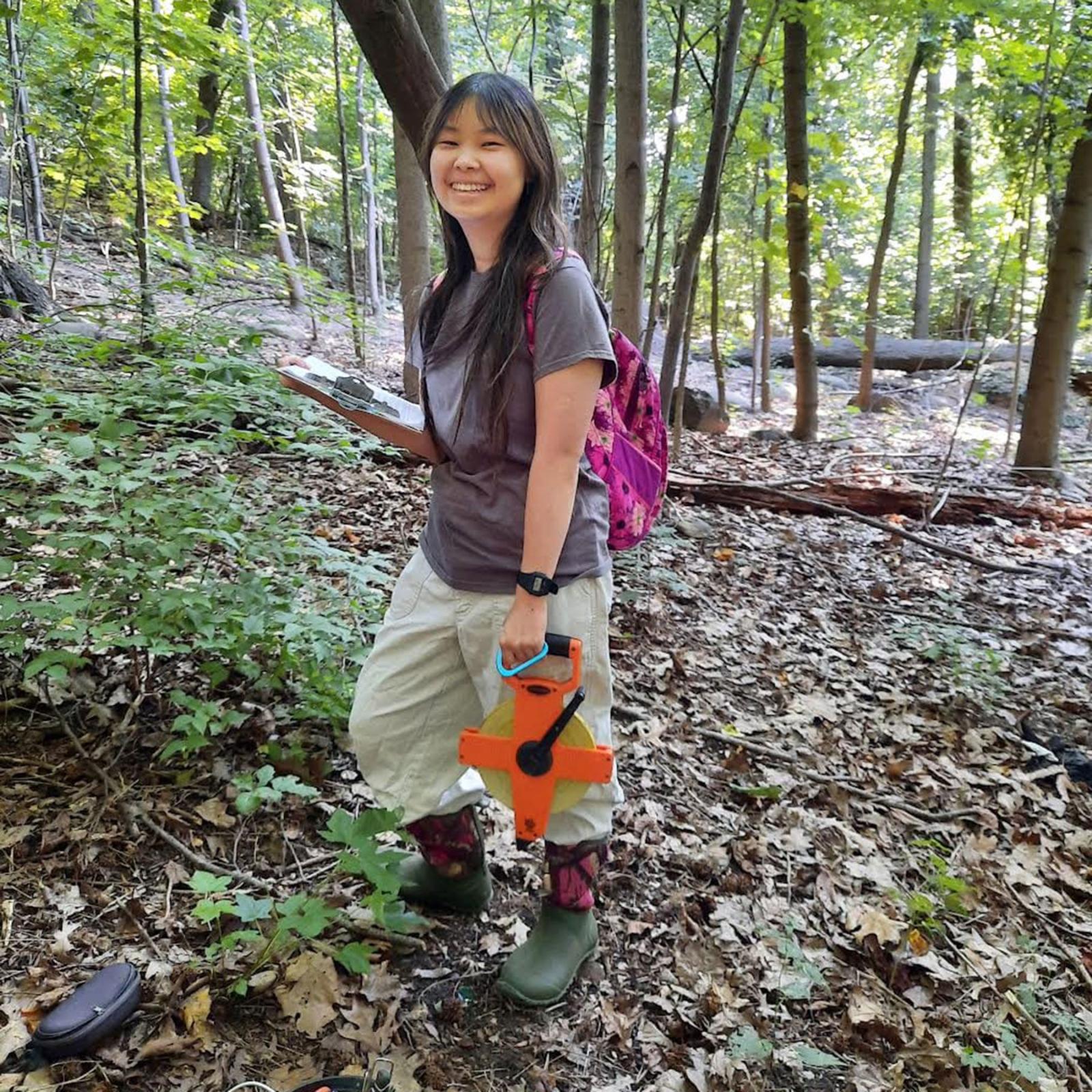 Pace University environmental studies and science student Talluah out in the woods