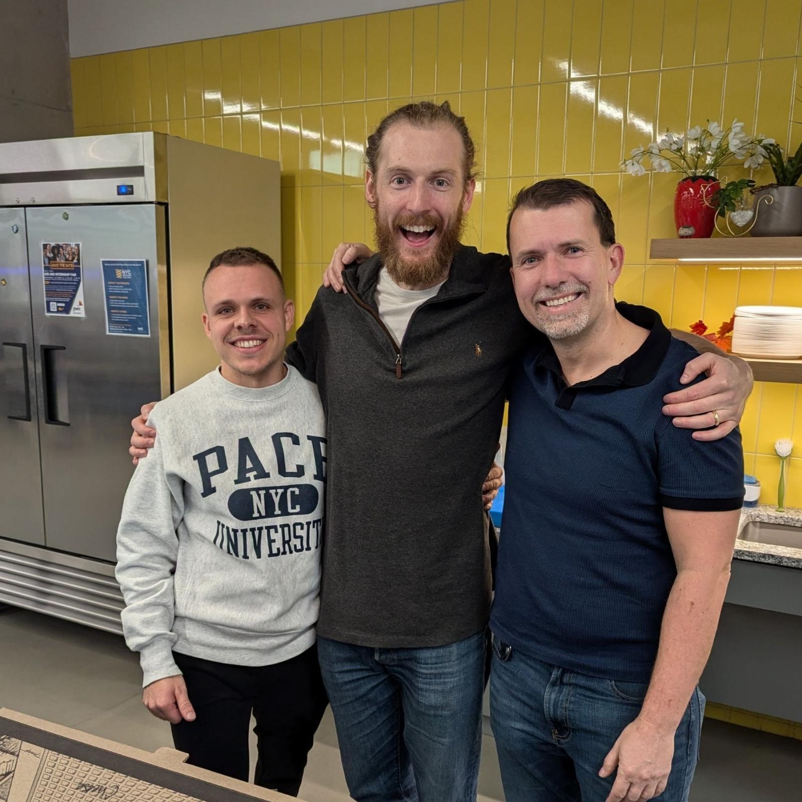 Pace Seidenberg student Fabian Hiller (L) posing for a photo with the Web Dev Meetup speakers in the Design Factory space of 15 Beekman.