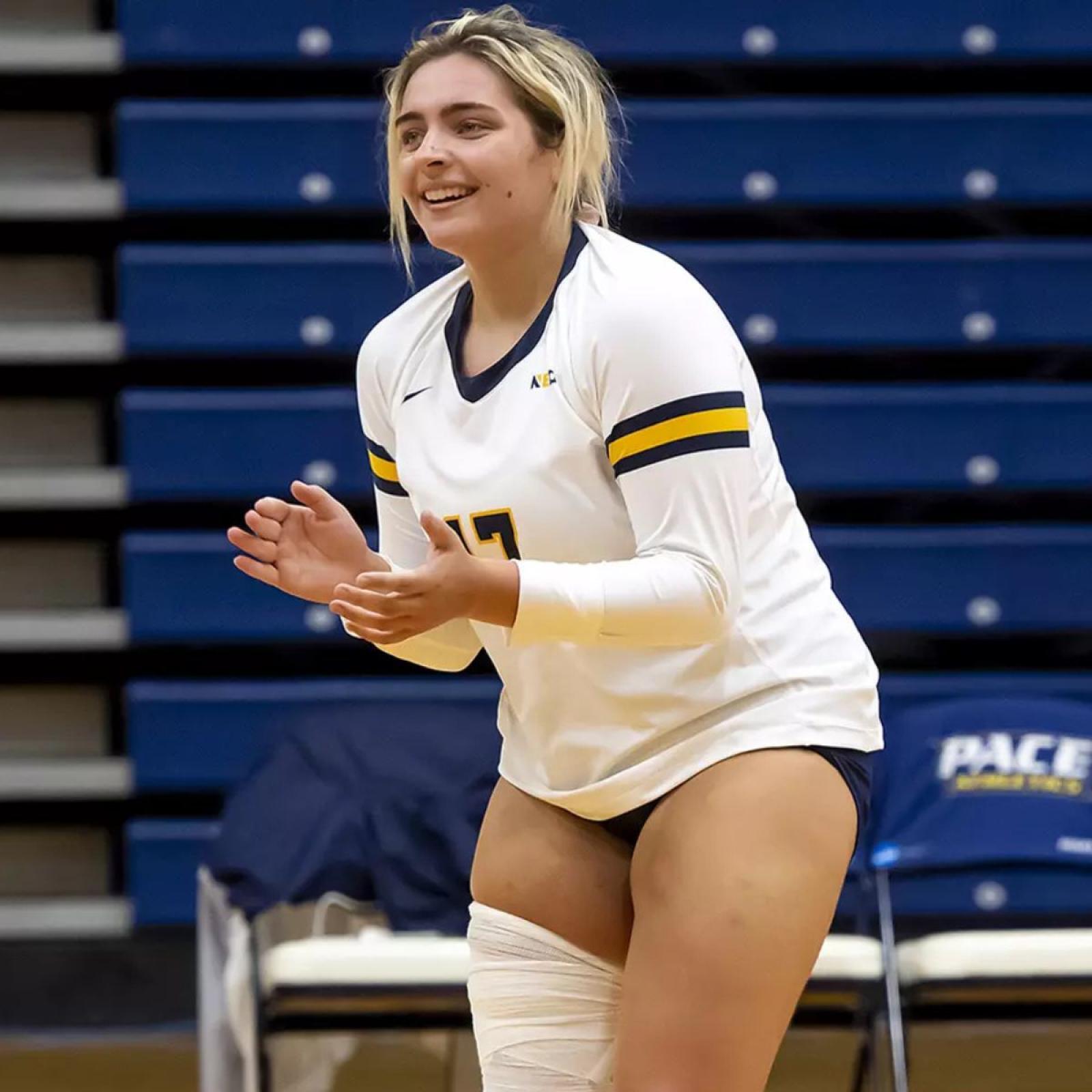 Stephanie Sicilian, student at Pace University's Seidenberg School of CSIS standing on the volleyball court during a game for Pace's women's volleyball team.