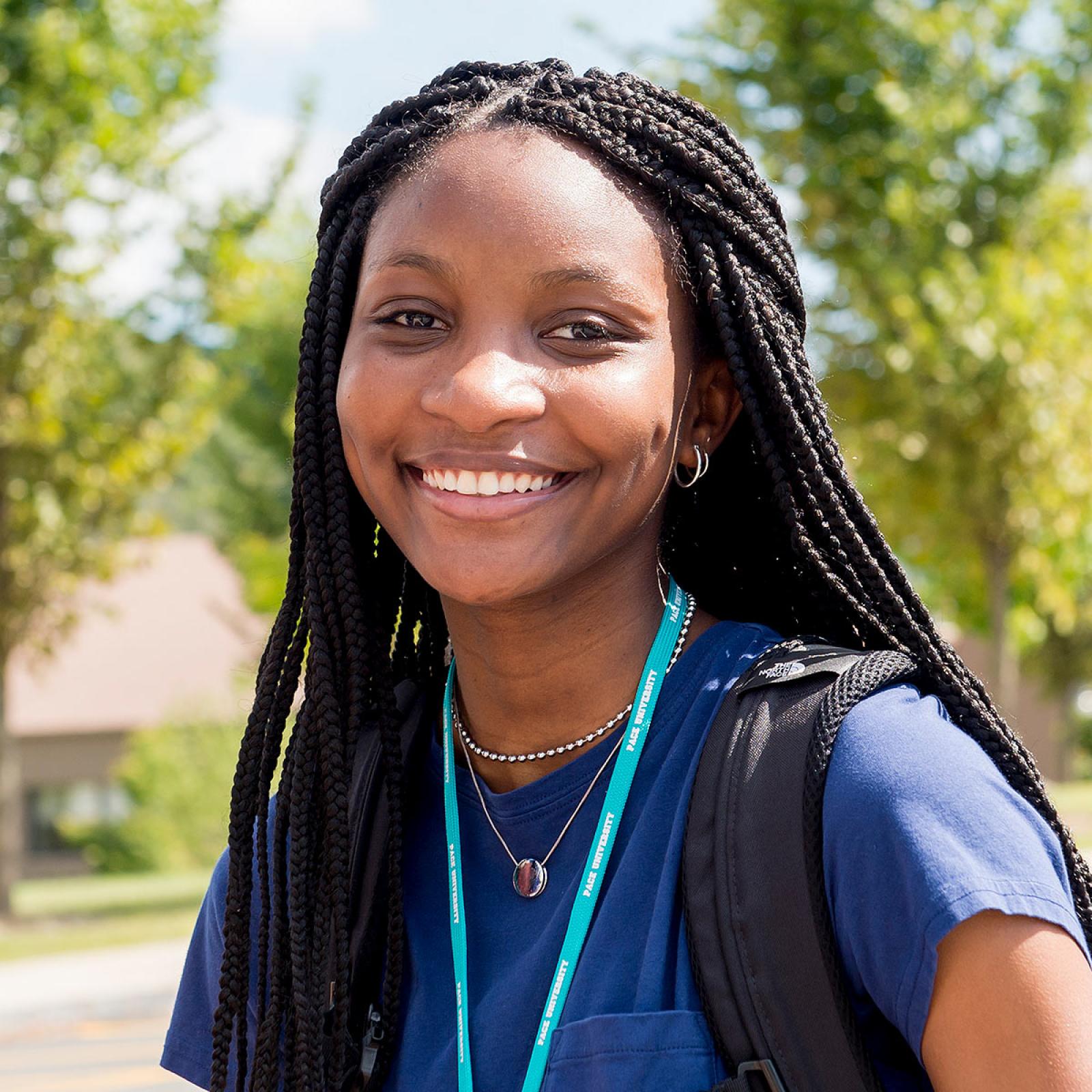 Pace University student smiling at the camera. 
