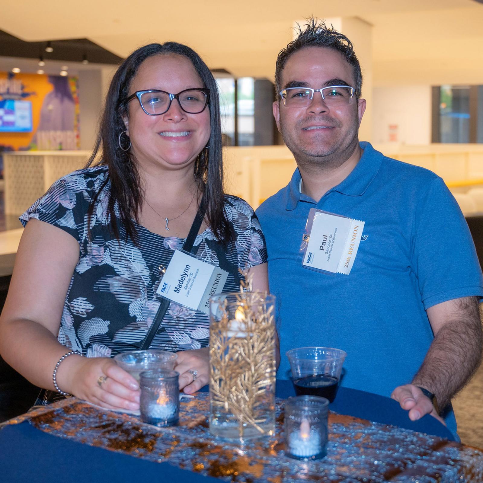 Two Pace Unievrsity alumni smiling at the camera at their 2025 Reunion.
