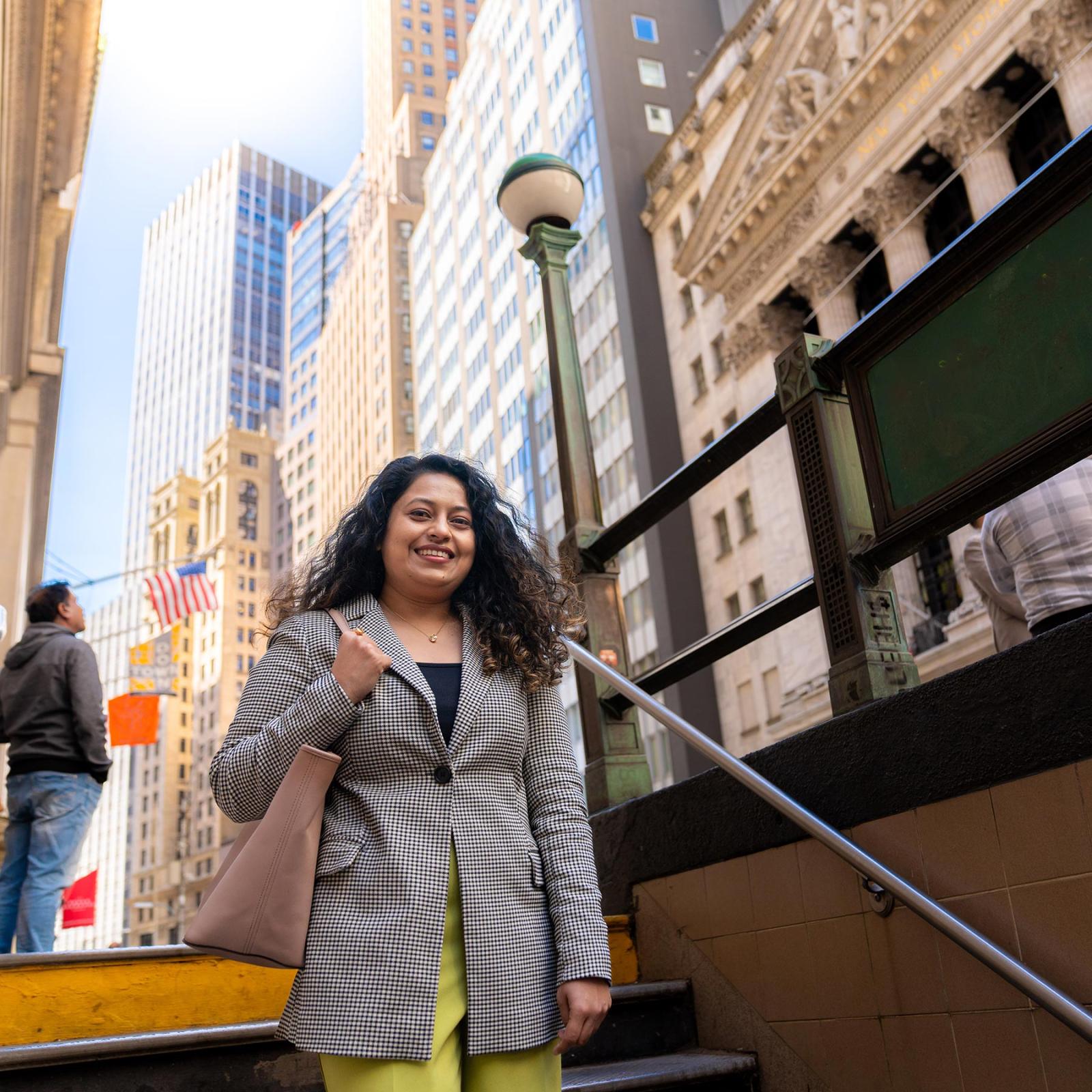 Pace student walking down subway stairs in NYC