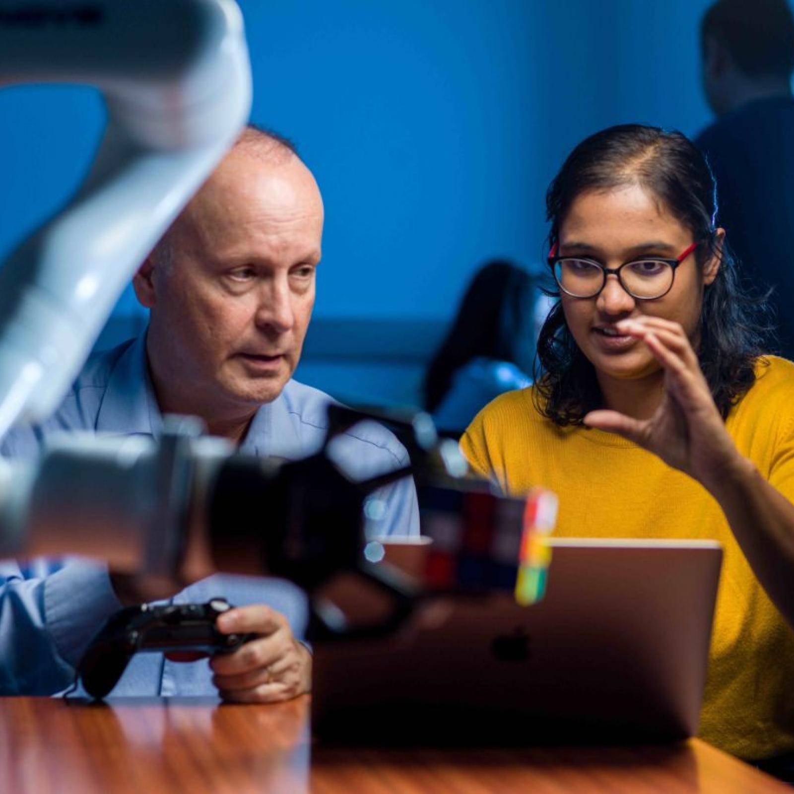 Pace University student working with her professor on a robotic's project.