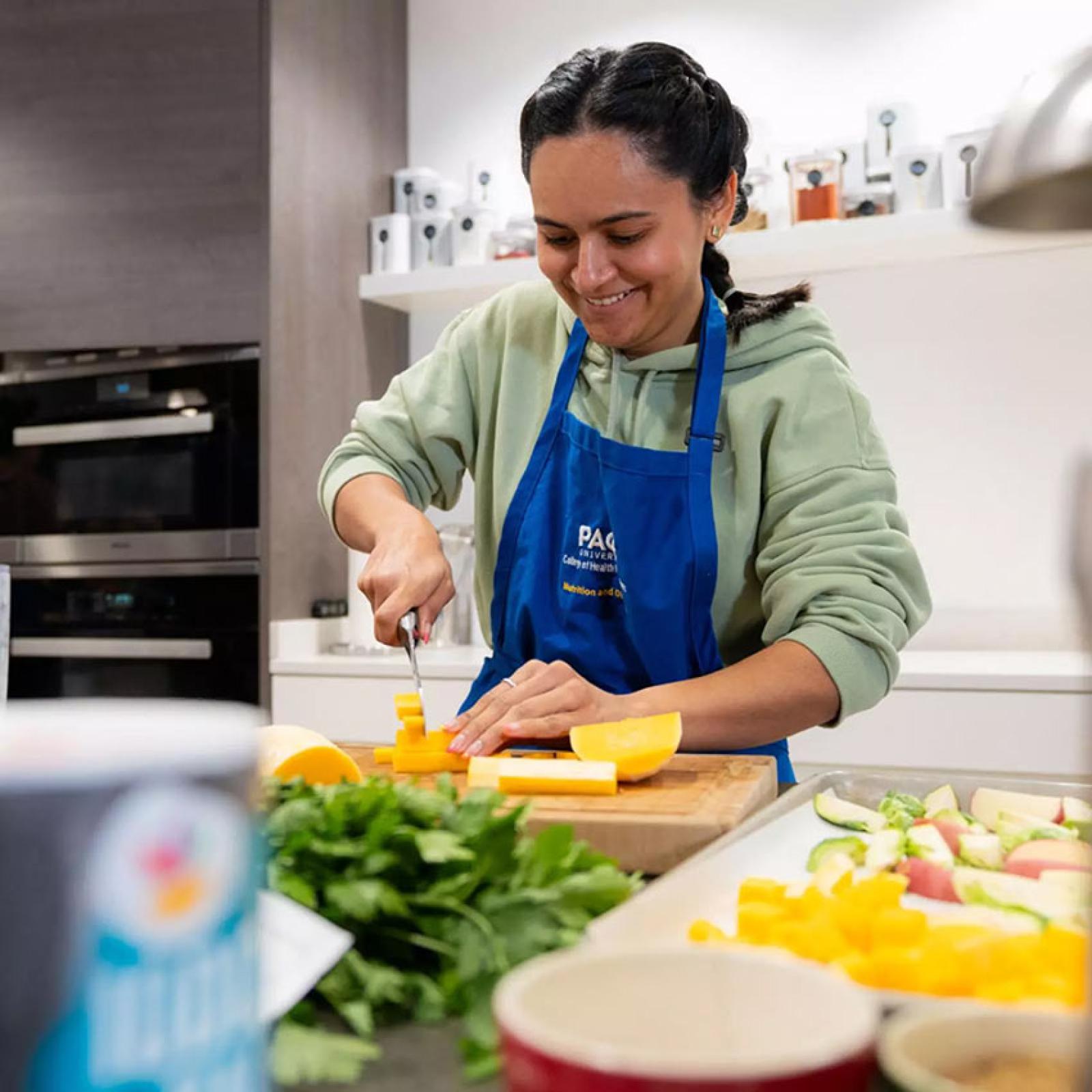 Pace University student cooking in a test kitchen.