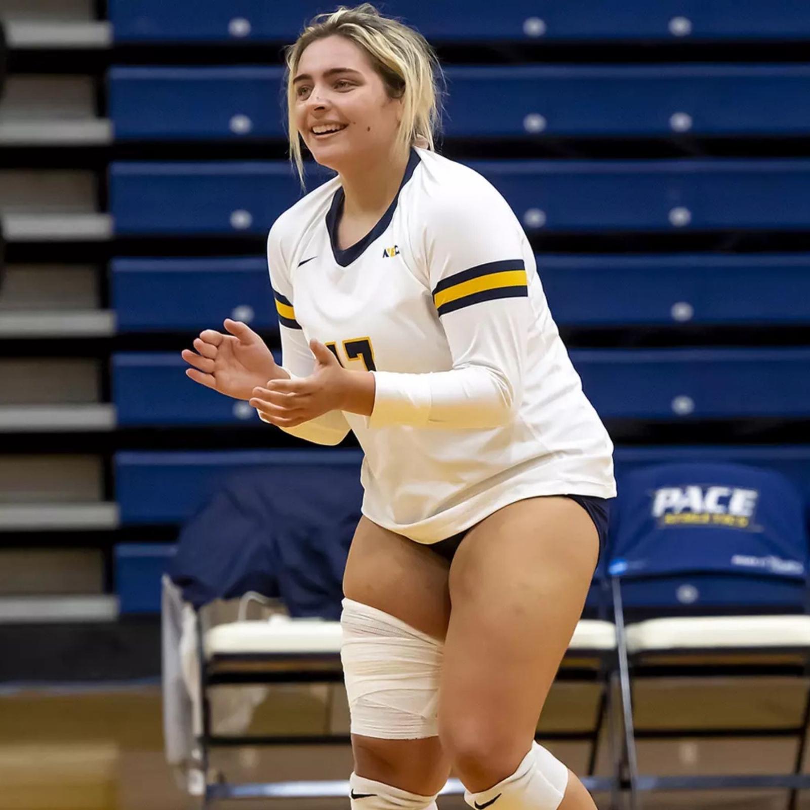 Stephanie Sicilian, student at Pace University's Seidenberg School of CSIS standing on the volleyball court during a game for Pace's women's volleyball team.