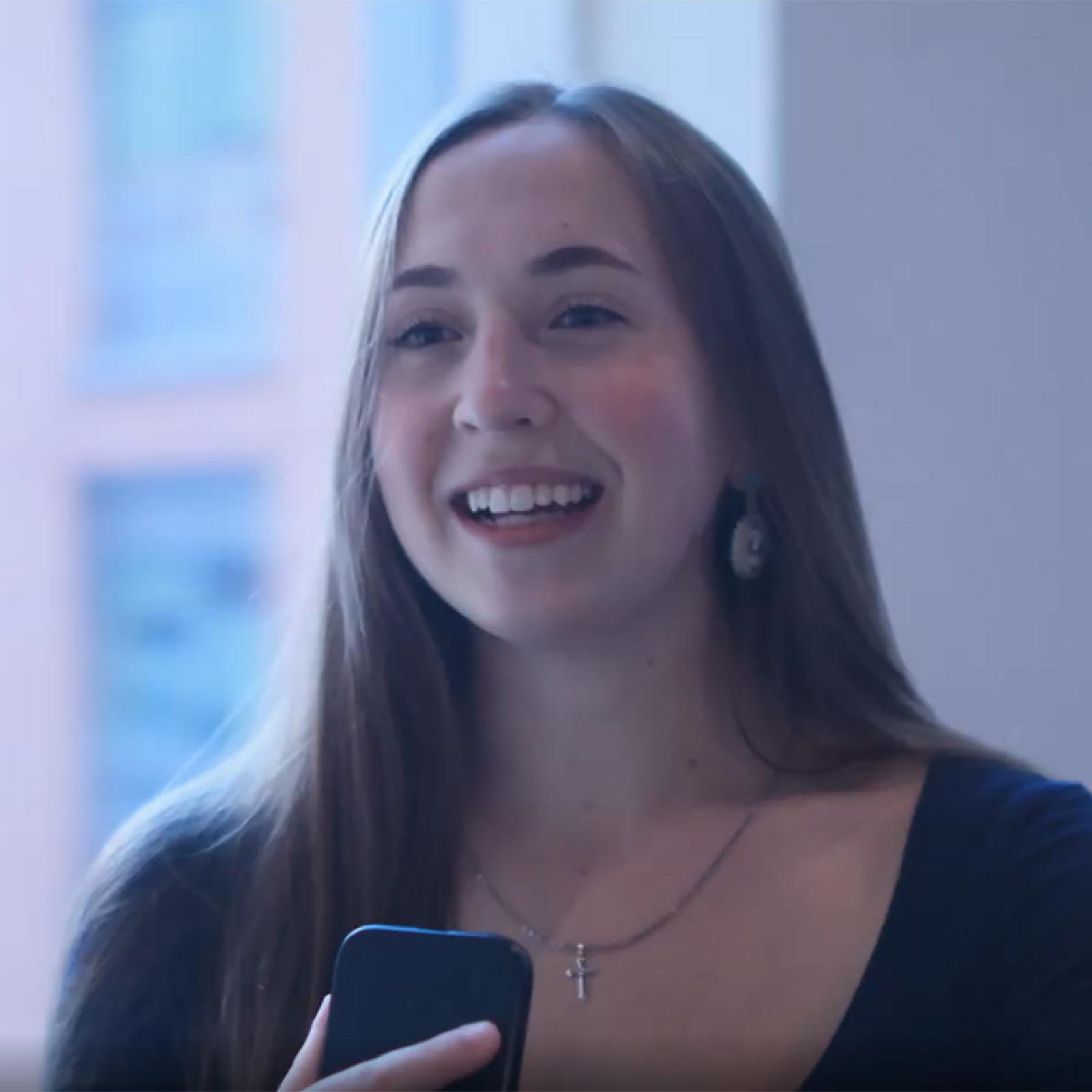 Pace University student speaks into a phonr