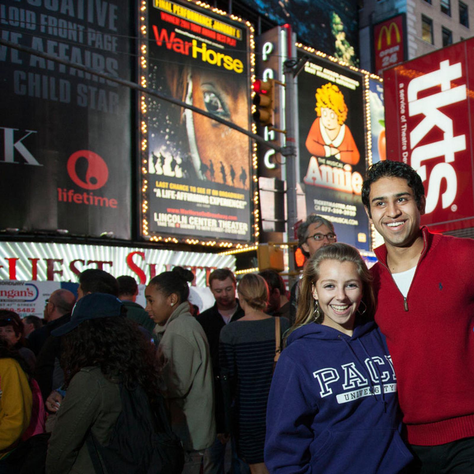 Two students posing for a photo in NYC's theatre district
