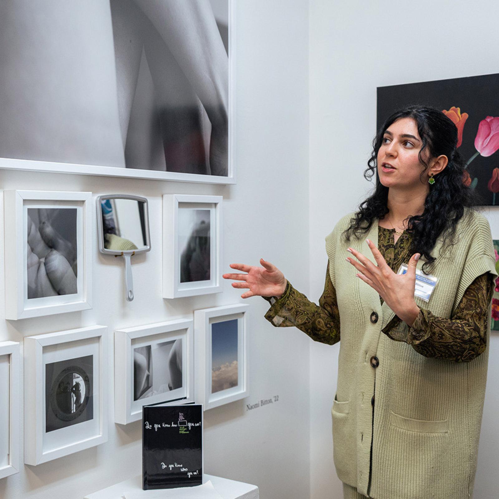 Pace University art student in a gallery discussion the art on the walls.