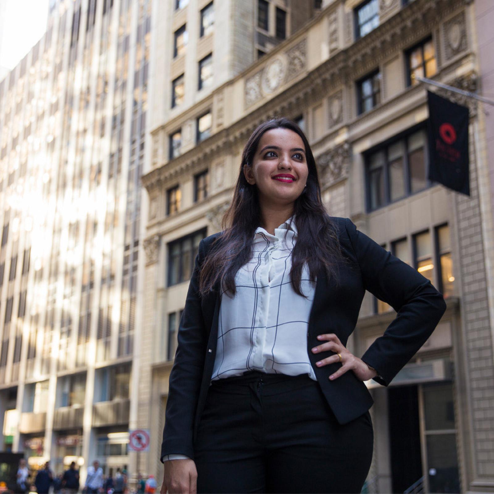 A woman in a skirt suit standing in FiDi. 