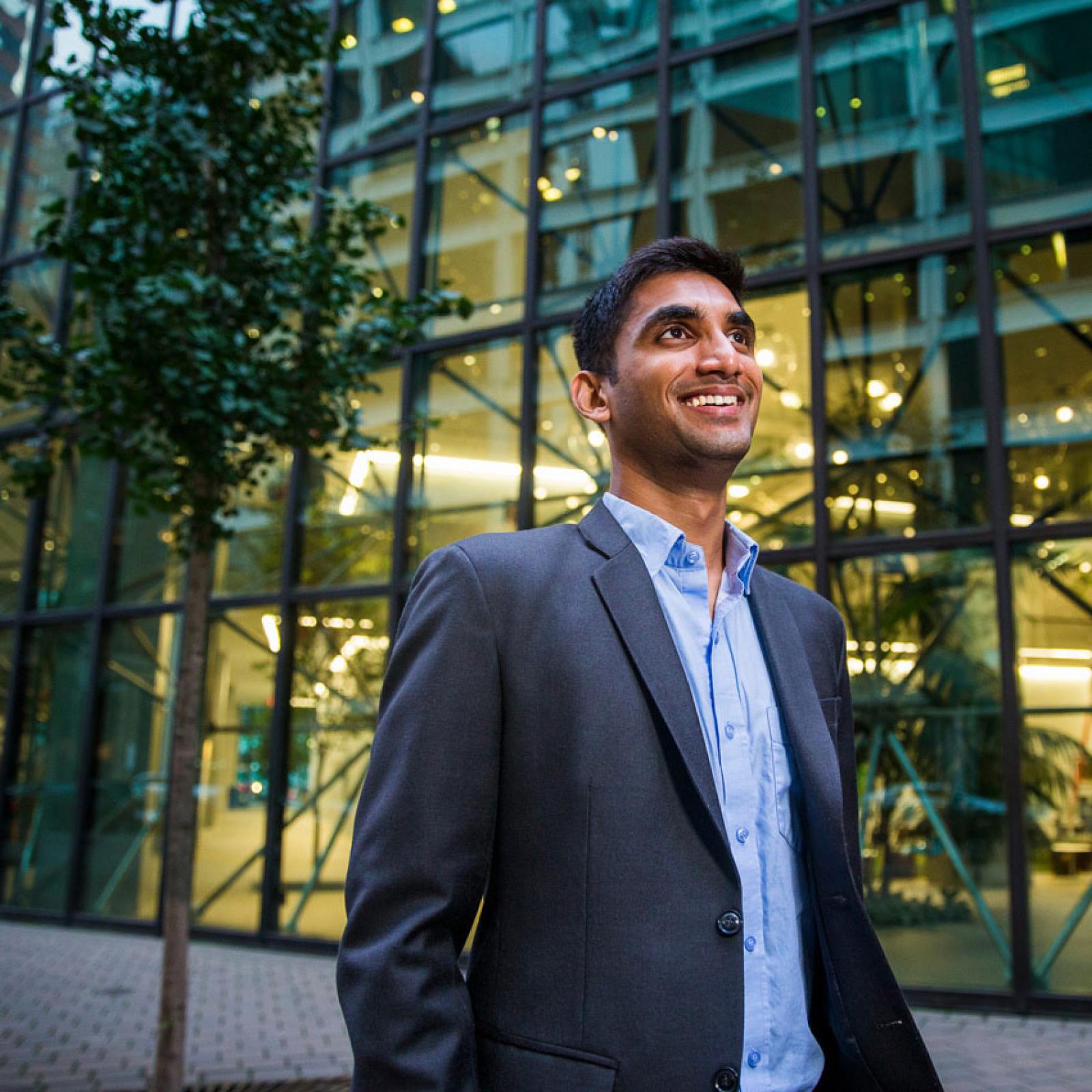 A man in a suit walking in NYC.