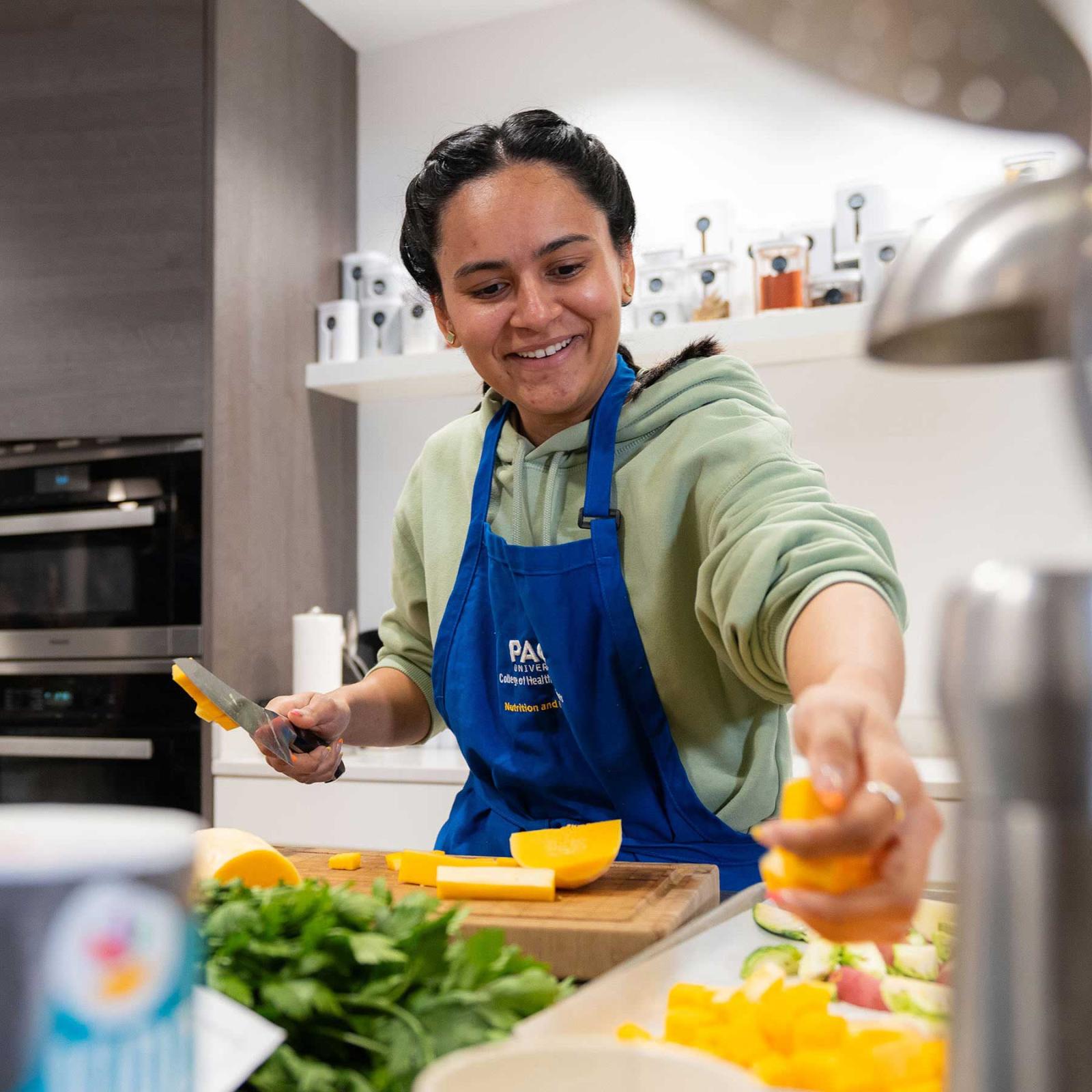 Student from the Pace University College of Health Professions, cooking in the Teaching Kitchen