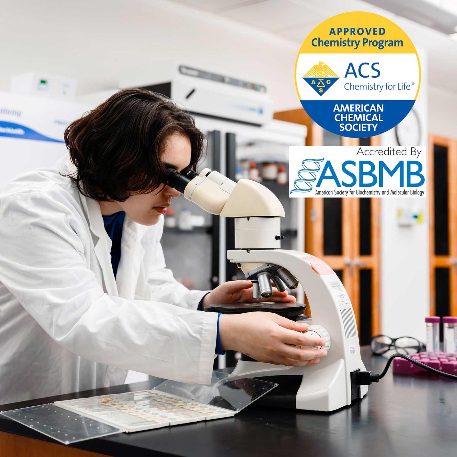 Pace University's New York City Chemistry lab student looking through a microscope