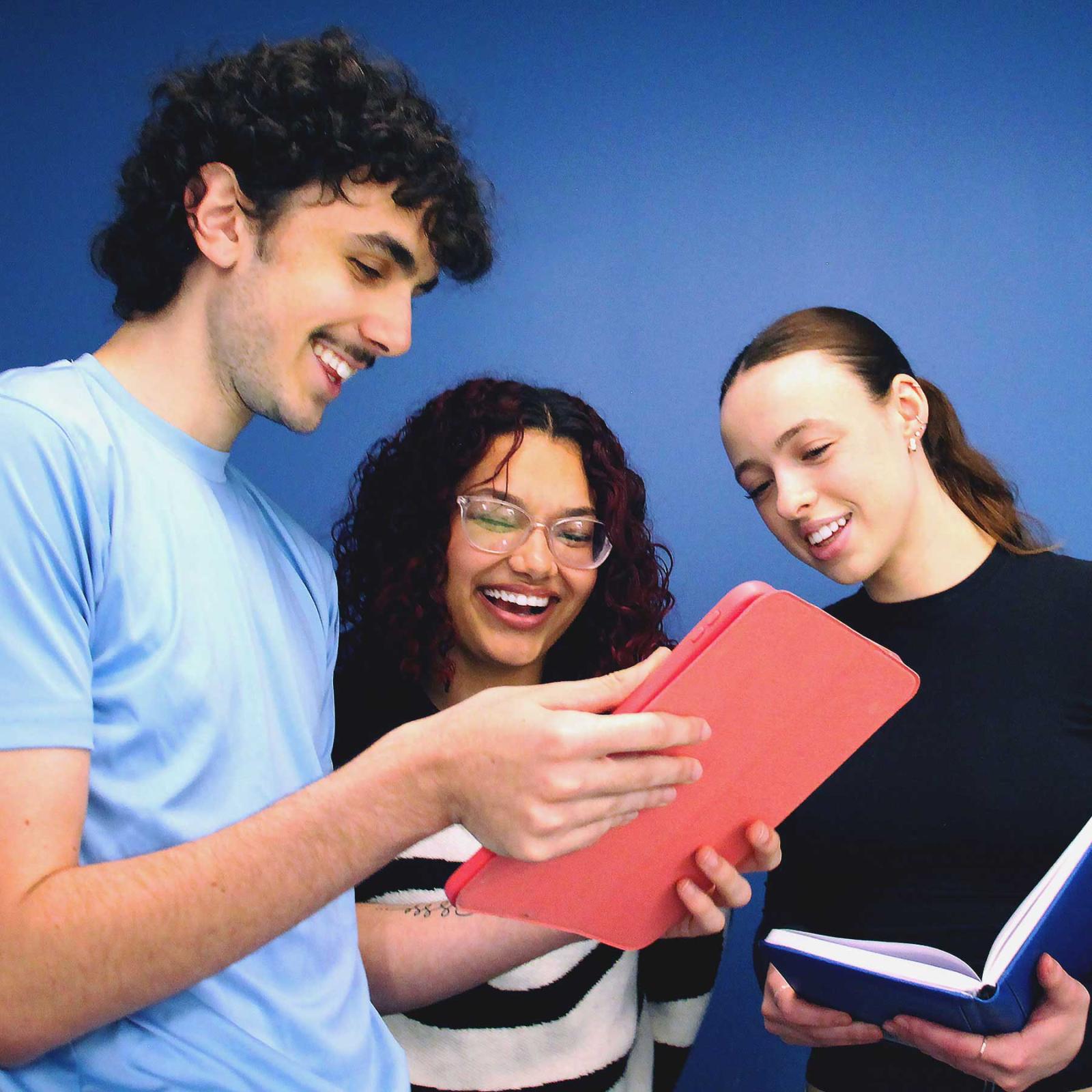Pace University students looking at media on iPad
